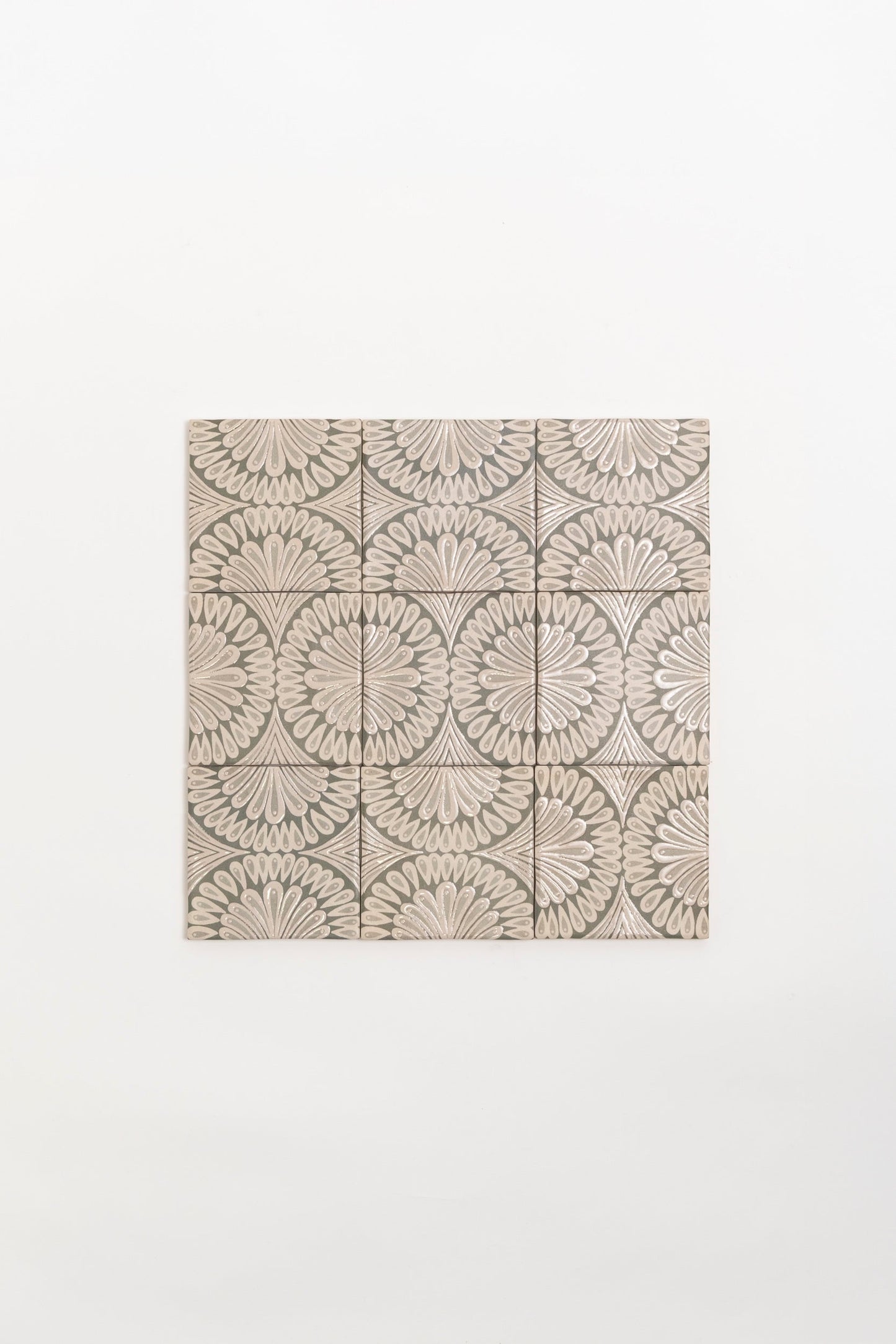 Poppy Deco by New York Cement Tile: nine square tiles with a repeating beige and gray floral fan pattern on white.