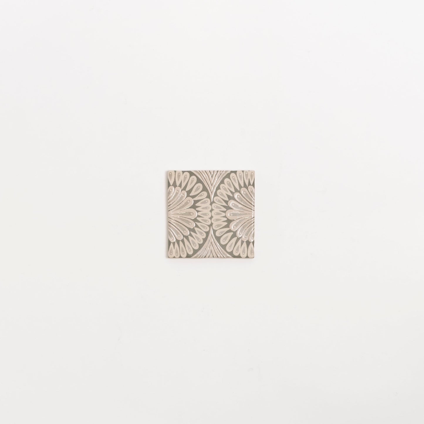 The Poppy Deco tile by Cottage Ivy features a beige petal geometric pattern on a light background, shown on white.
