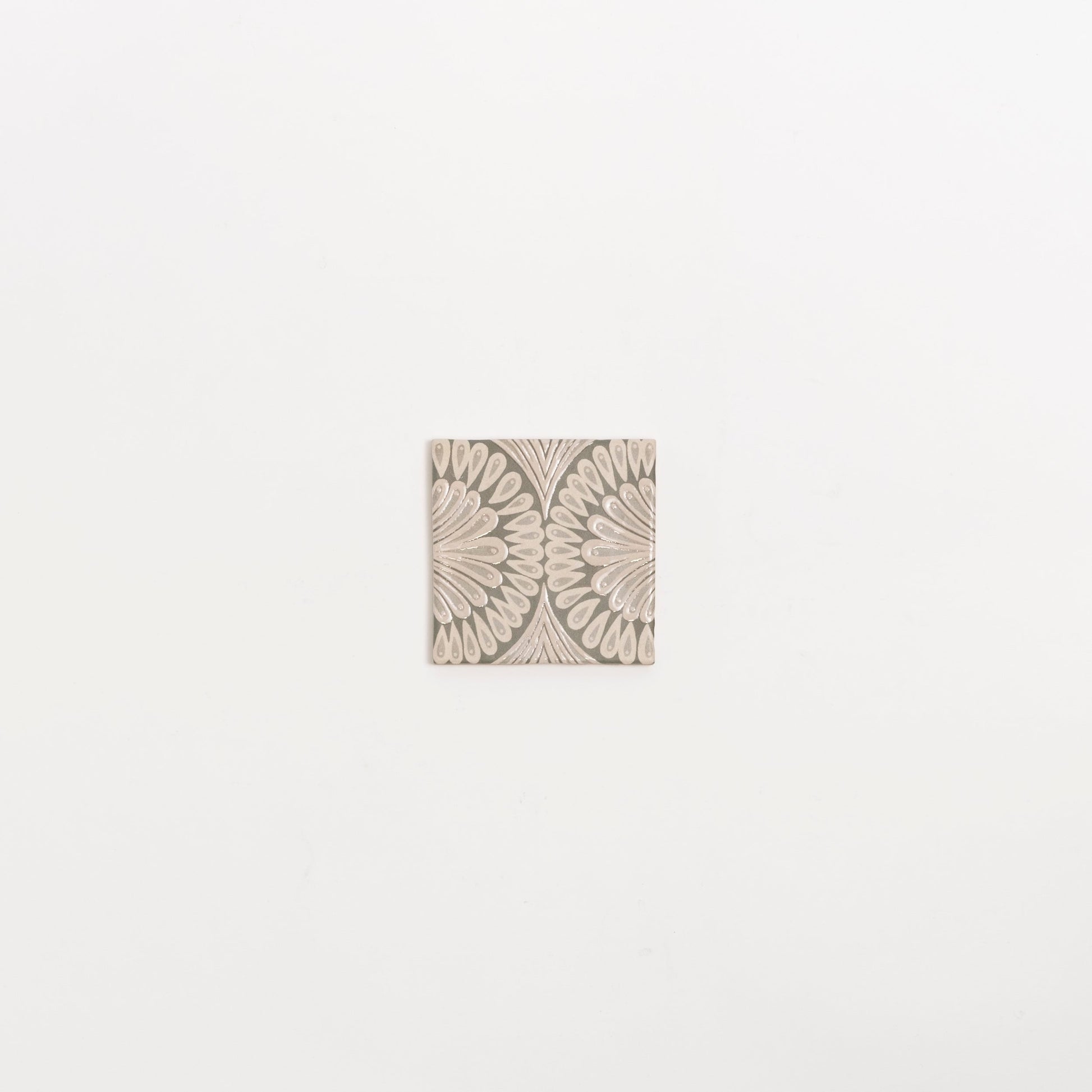The Poppy Deco tile by Cottage Ivy features a beige petal geometric pattern on a light background, shown on white.