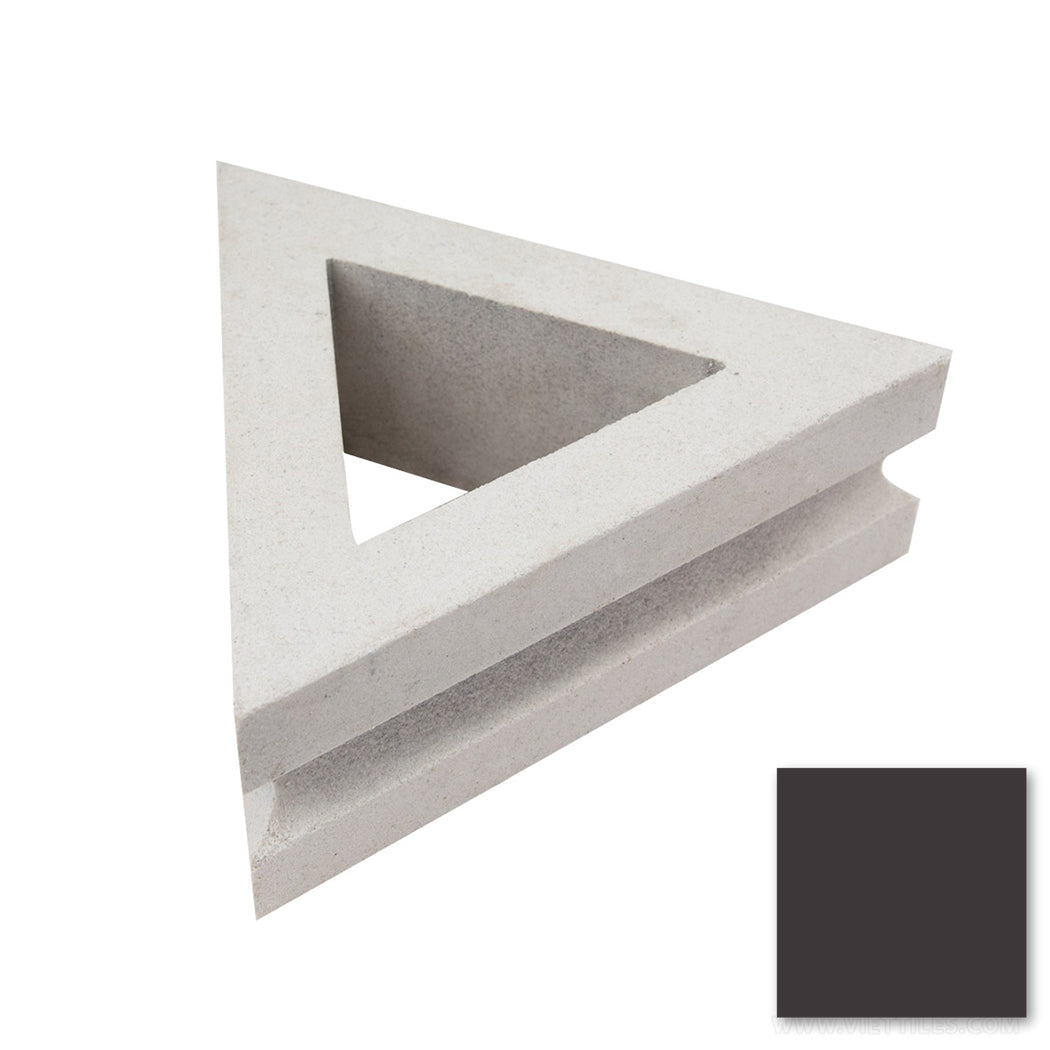 The Rapa Nui Triangular, Extra Sample by New York Cement Tile is a gray, hollow block with a grooved edge.