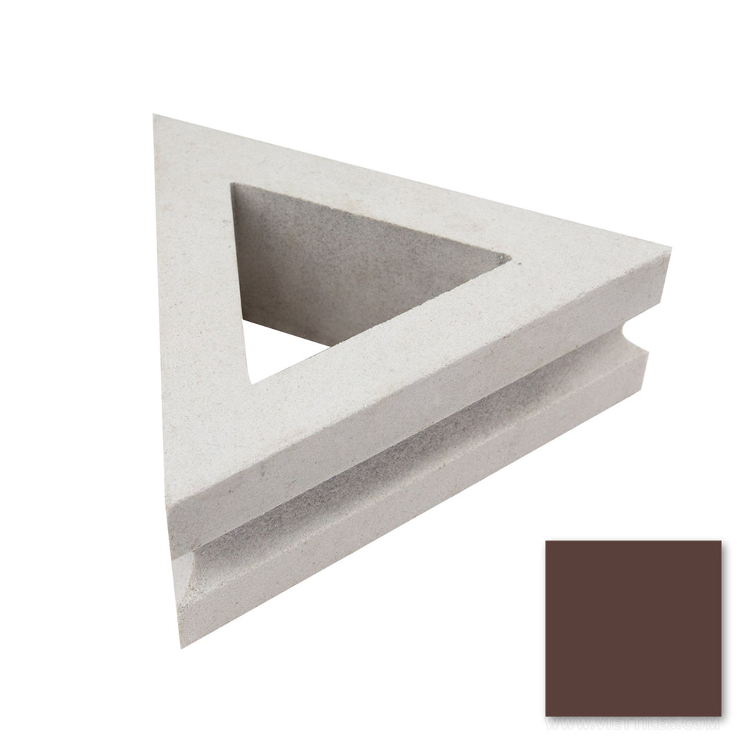 Nui Triangular breeze block by New York Cement Tile, shown with a brown color swatch in the bottom right corner.