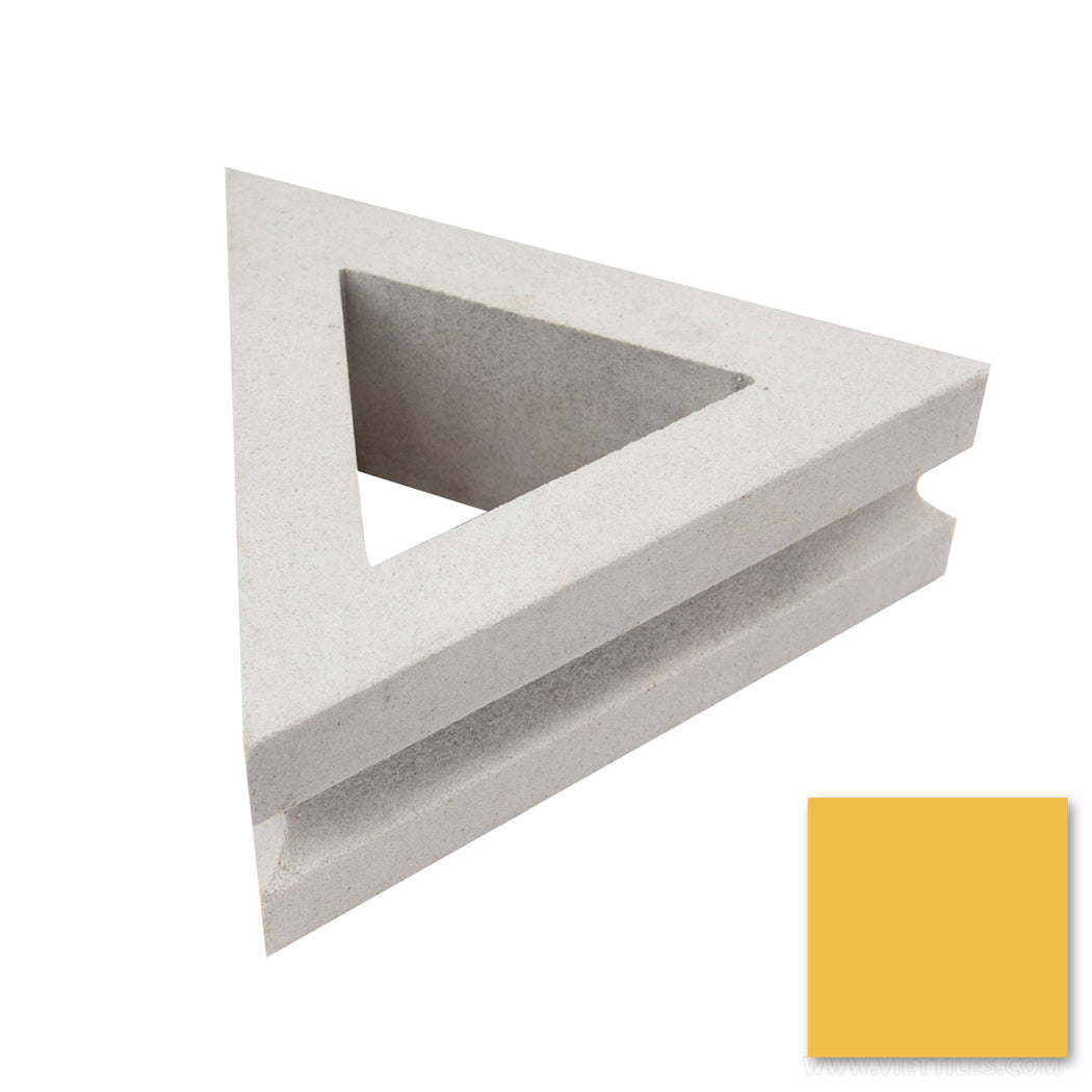 The Nui Triangular by New York Cement Tile is shown next to a mustard yellow swatch on a white background.
