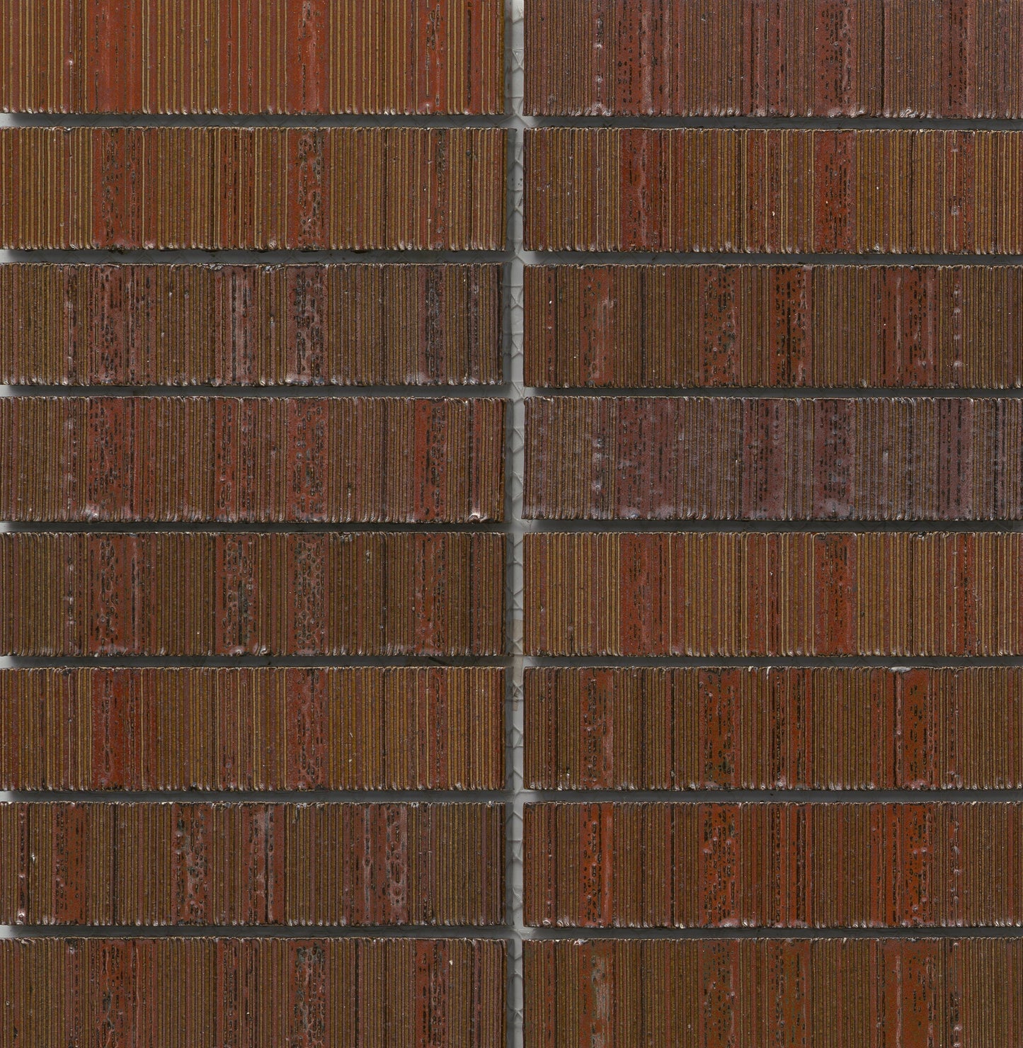 Close-up of Red - Newtro - Sample tiles by New York Cement Tile, featuring grooved textures and thin gray grout lines.