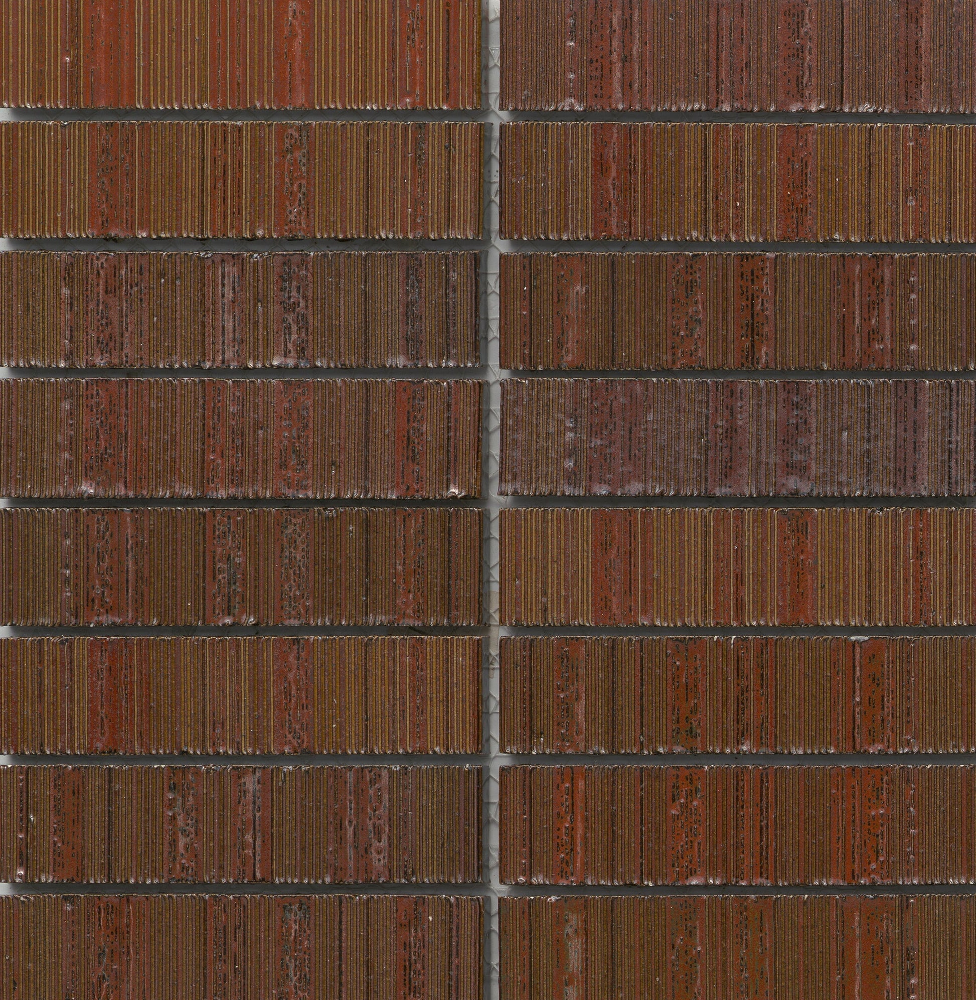 Close-up of Red - Newtro - Sample tiles by New York Cement Tile, featuring grooved textures and thin gray grout lines.