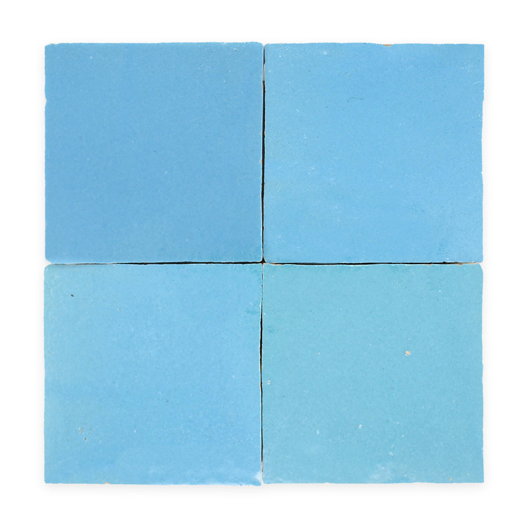 Four light blue square tiles arranged in a two-by-two grid on a white background.