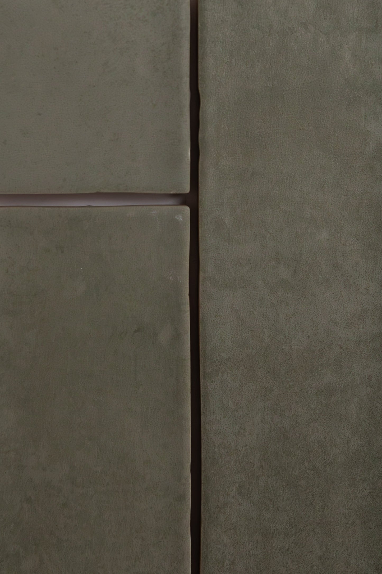 Close-up of four matte Skye Green tiles by Cottage Ivy with visible grout lines arranged in a grid pattern.