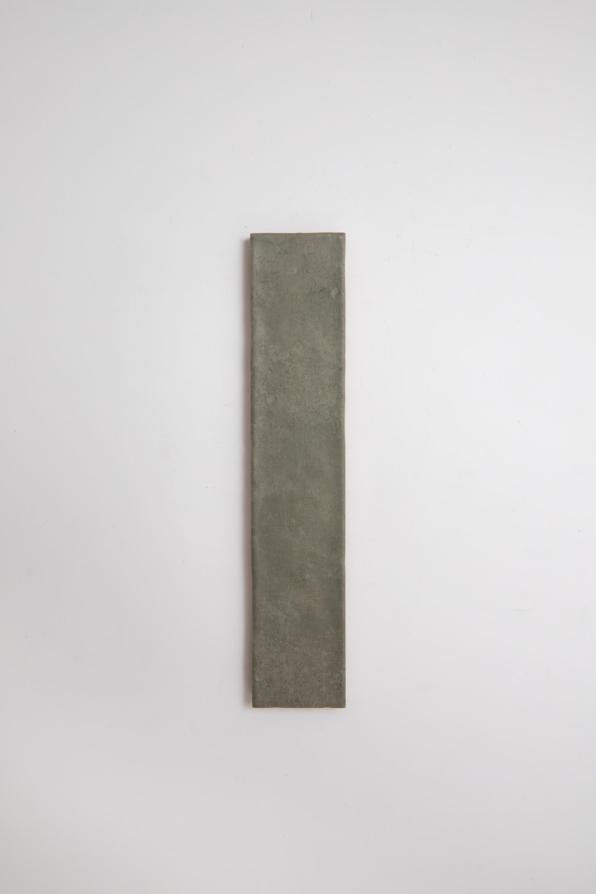 A tall, narrow, rectangular Skye Green tile by Cottage Ivy is centered on a plain white background.
