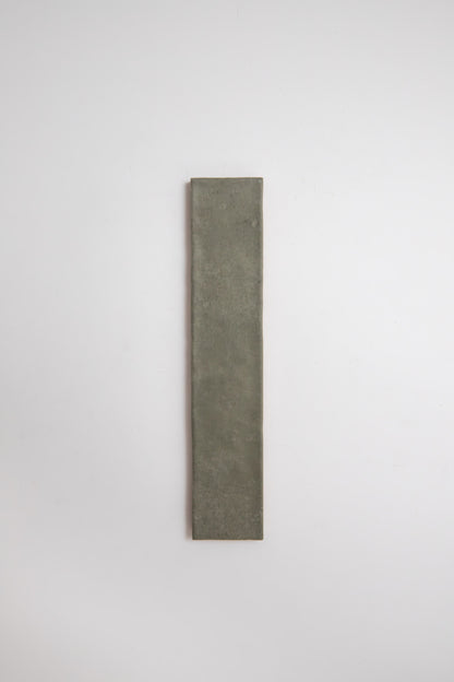 A tall, narrow, rectangular Skye Green tile by Cottage Ivy is centered on a plain white background.