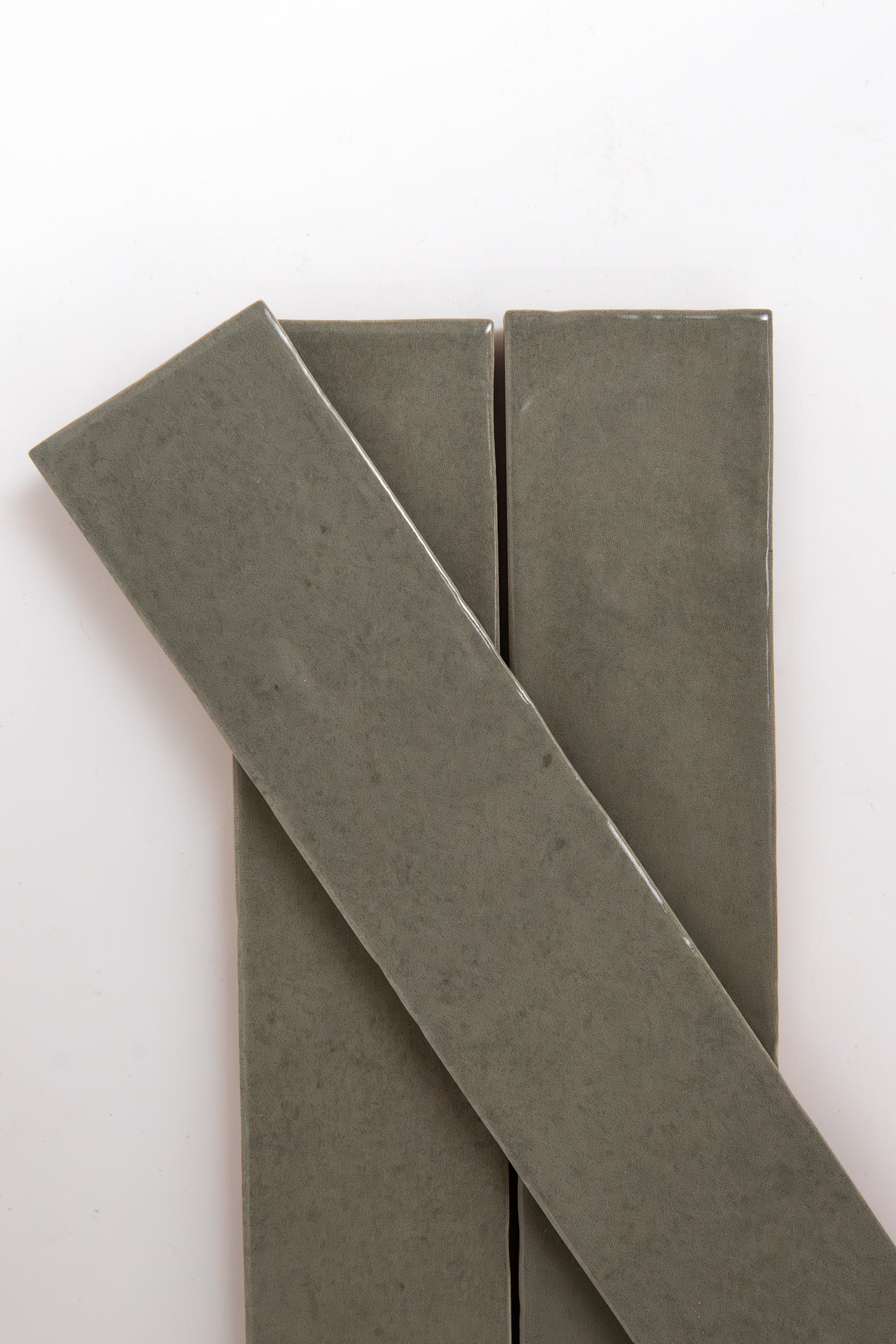 Three Skye Green tiles by Cottage Ivy on a white background—two vertical, one diagonally arranged.