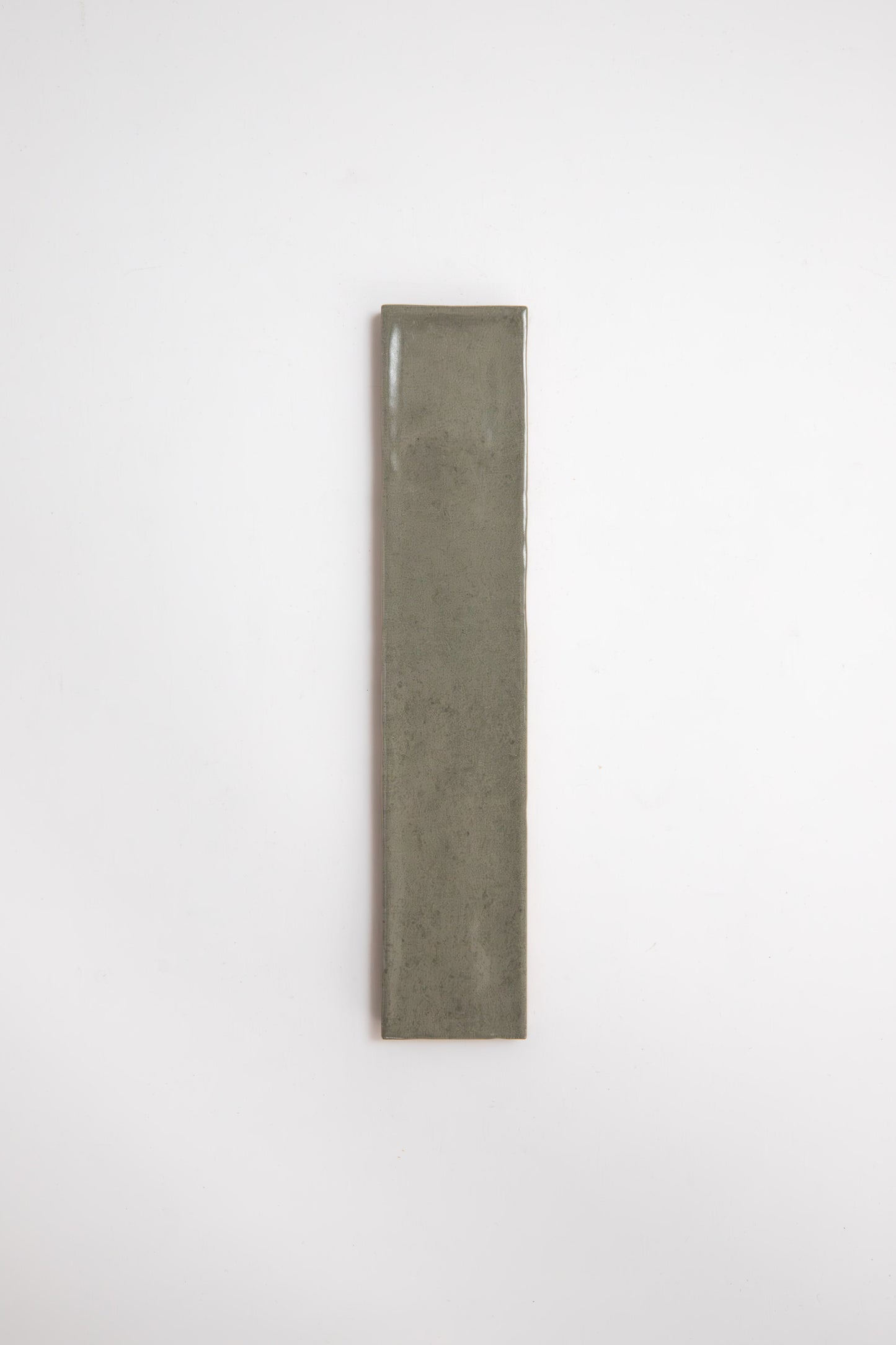 A single Skye Green tile sample by Cottage Ivy, rectangular and olive-green, on a plain white background.