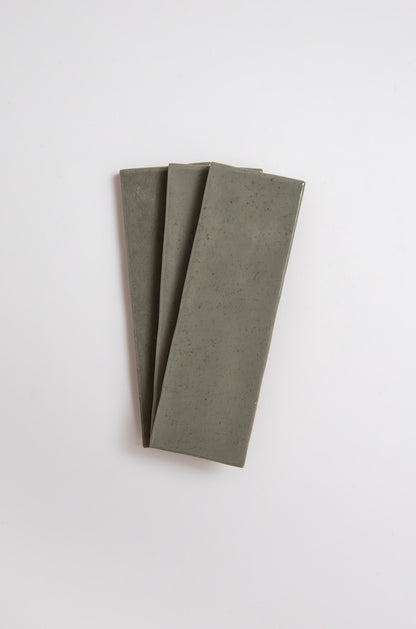 Three Skye Green ceramic tiles from Cottage Ivy arranged in a fan shape on a white background.