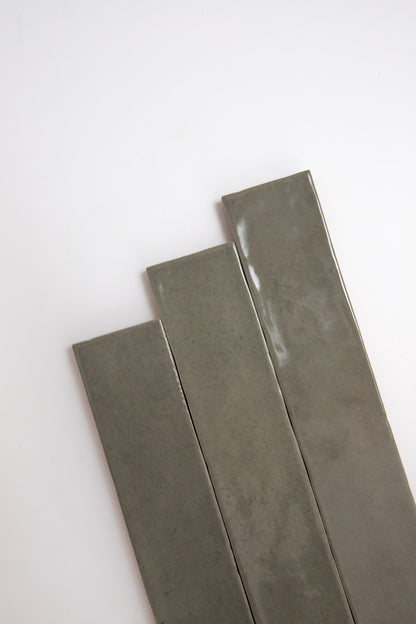 Three long, rectangular Skye Green, Extra Sample tiles by Cottage Ivy arranged diagonally on a white background.