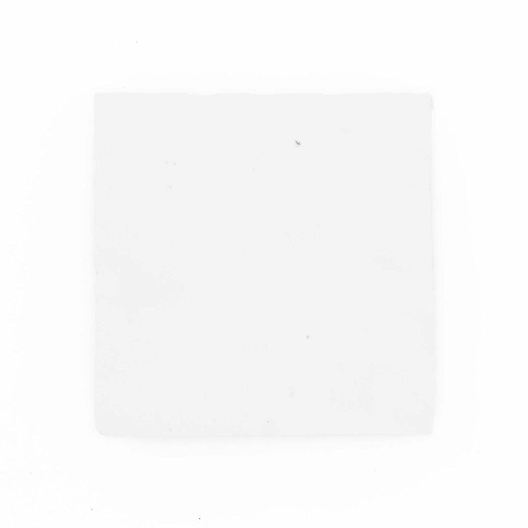The Frost, Extra Sample napkin by New York Cement Tile sits on a handcrafted tile-like background.