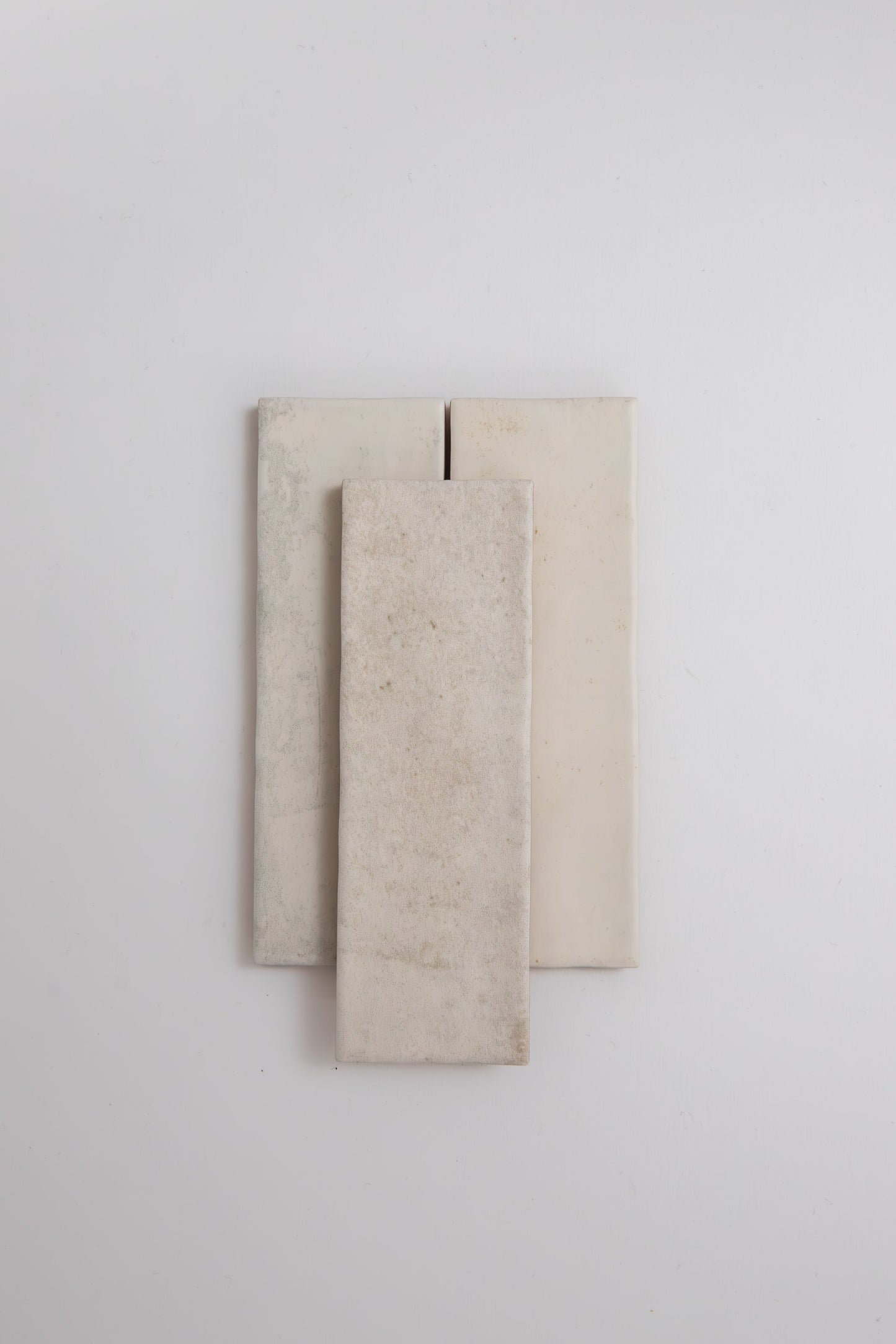 Three Snowshill White samples by Cottage Ivy arranged vertically on a plain white background.