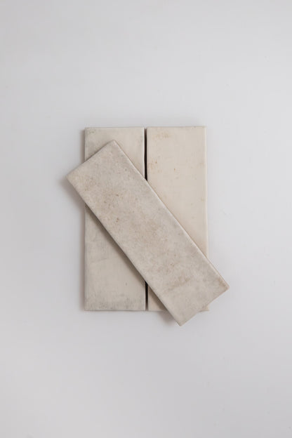 Three Snowshill White tile samples by Cottage Ivy, with one tile diagonally stacked over two vertical tiles.