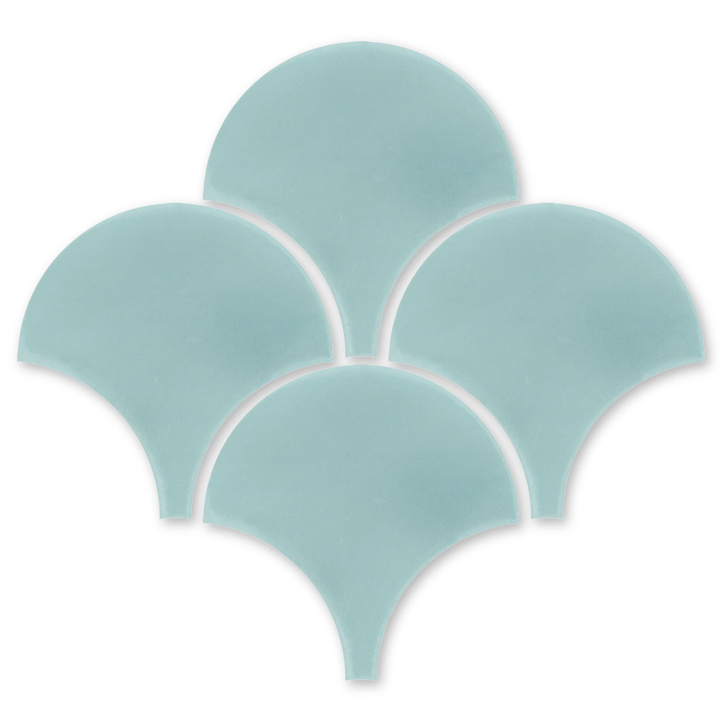 Five light blue, fan-shaped NF20-4402 Velvet Fishscale tiles by New York Cement Tile in a semi-circular pattern.