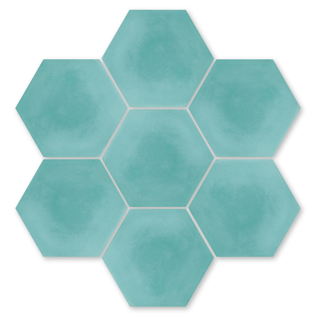 Seven NH23-4420 teal hex tiles by New York Cement Tile arranged in a honeycomb pattern on white.