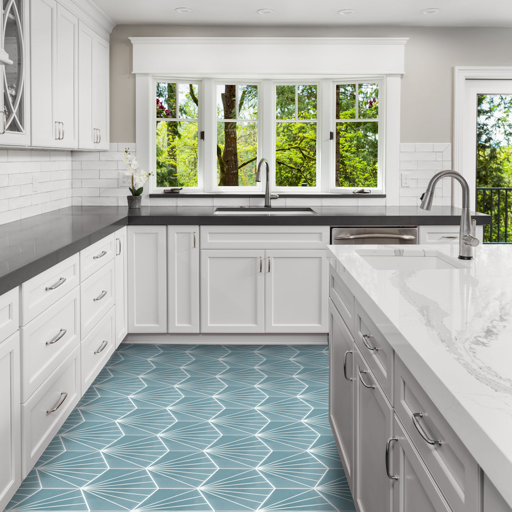 Modern white kitchen with NH23-036 - 4401 geometric blue tiles by New York Cement Tile and stainless appliances.