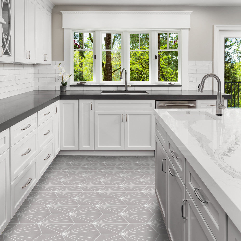 Modern kitchen features New York Cement Tile NH23-036 -G&W2219 floor, white cabinets, gray counters, and large windows.