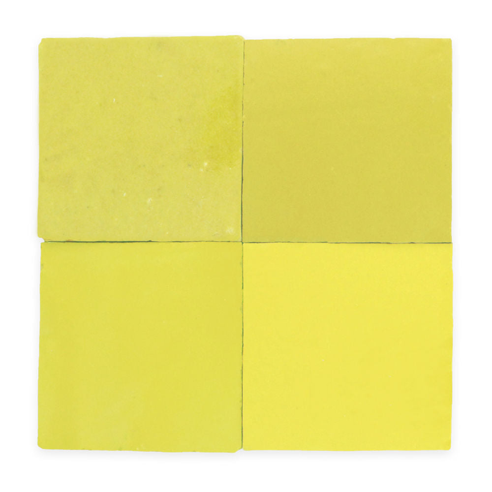 Four square yellow tiles arranged in a 2x2 grid, each tile slightly different in shade and texture.