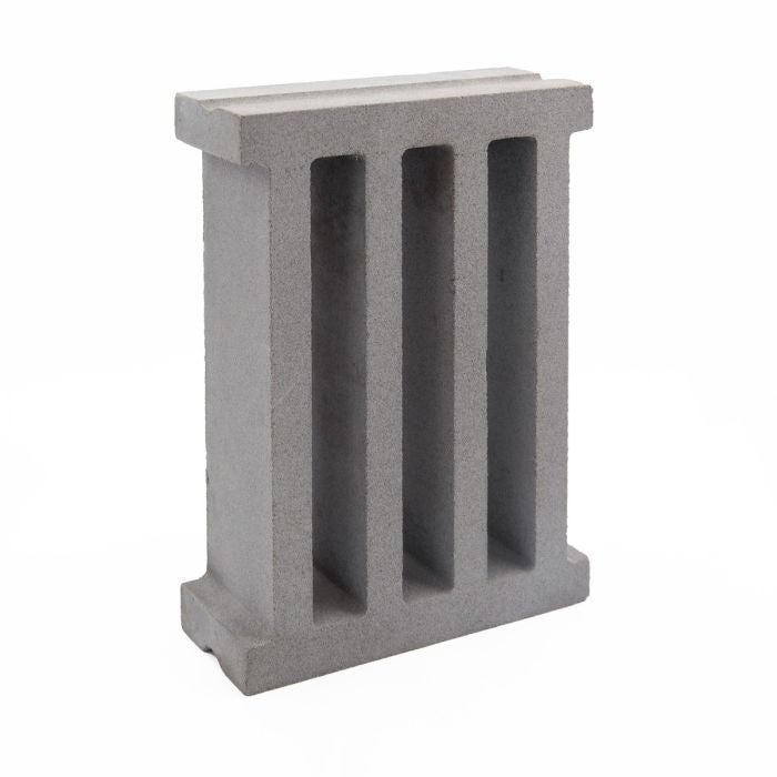 The Taz Sample by New York Cement Tile is a gray breeze block with three vertical openings, shown on a white background.