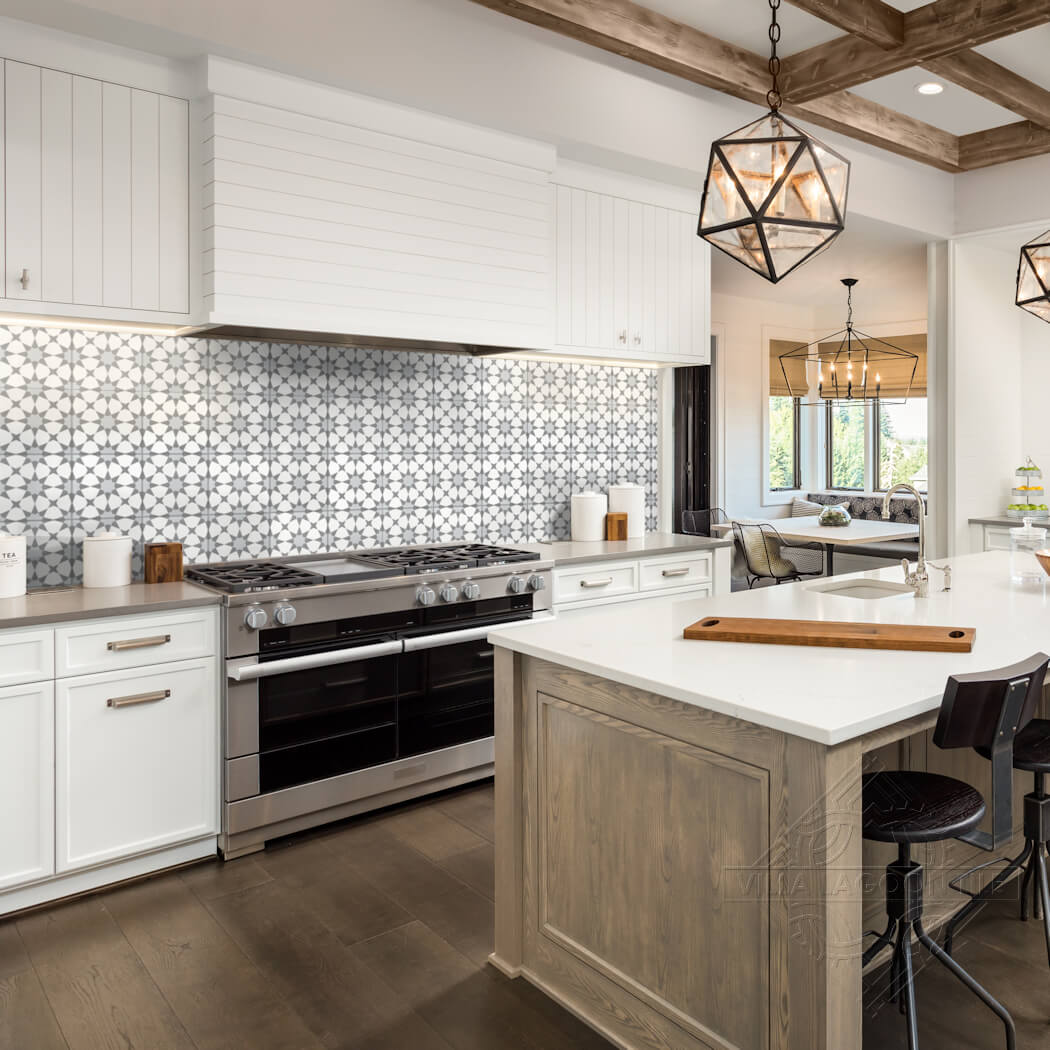 Modern kitchen with N20-271 Silver by New York Cement Tile, white cabinets, wood island, and stainless appliances.