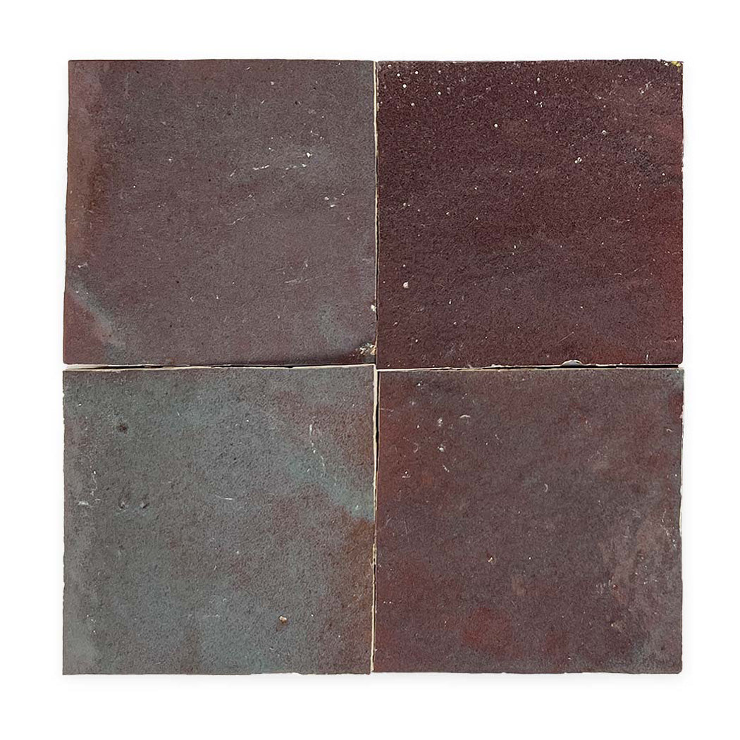 Four square, dark reddish-brown ceramic tiles are arranged in a two-by-two grid on a white background.