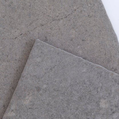 The Toba Basilica R11 by New York Cement Tile is a square gray stone tile with a rough texture on a white background.