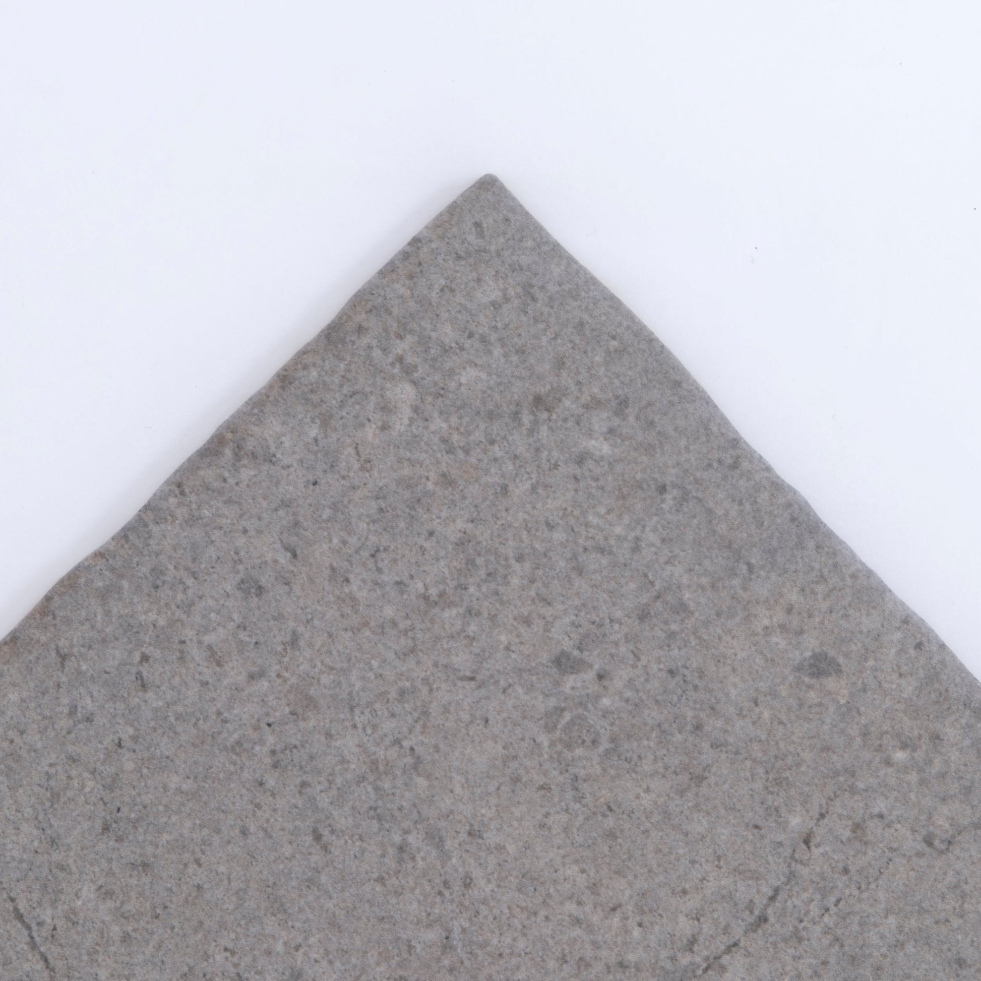 The Toba Basilica R11 Sample tile by Toba features a pointed corner and gray stone finish on a white background.