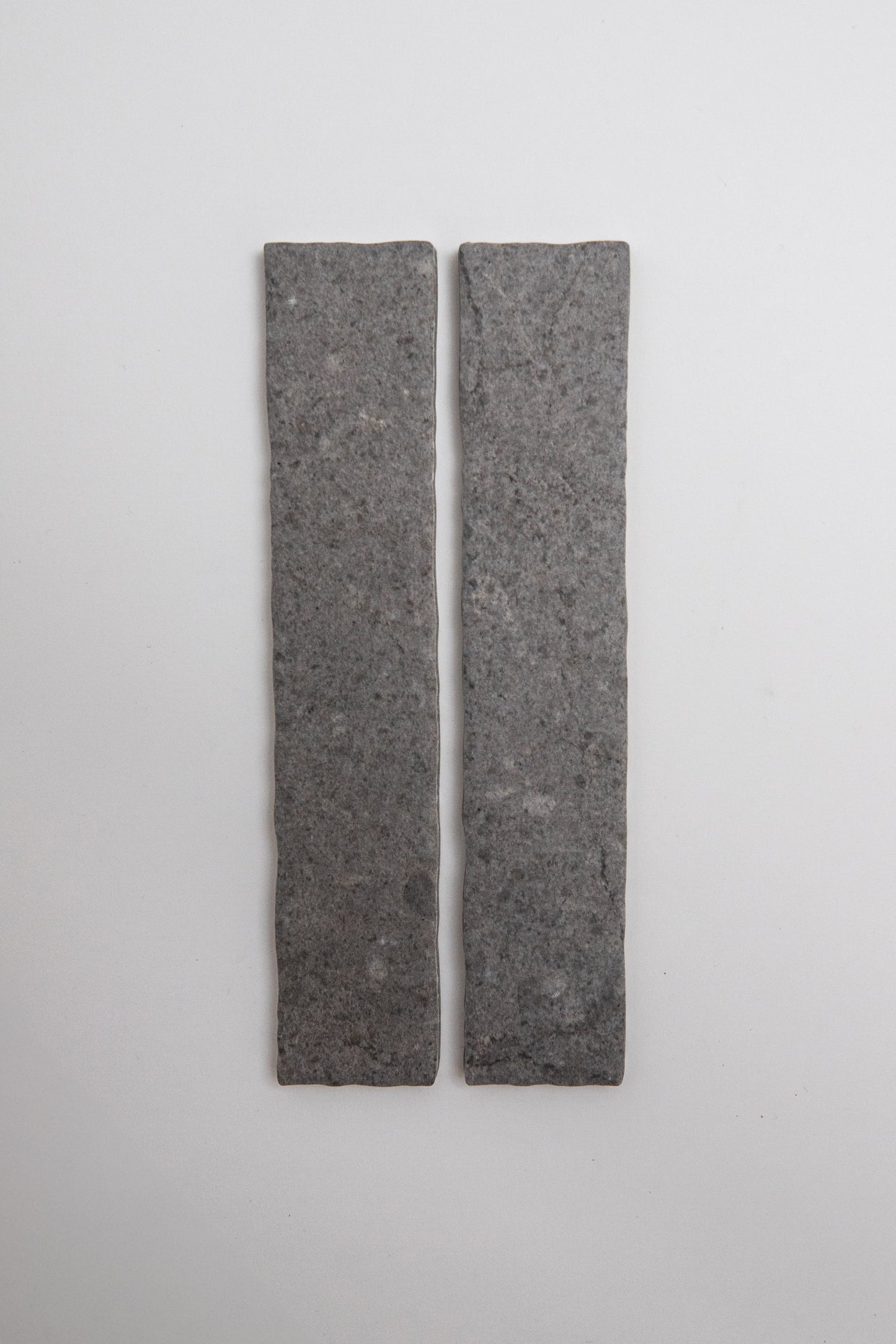 Two rectangular Toba Basilica R11, Sample tiles by Toba stand vertically side by side on a plain, light background.