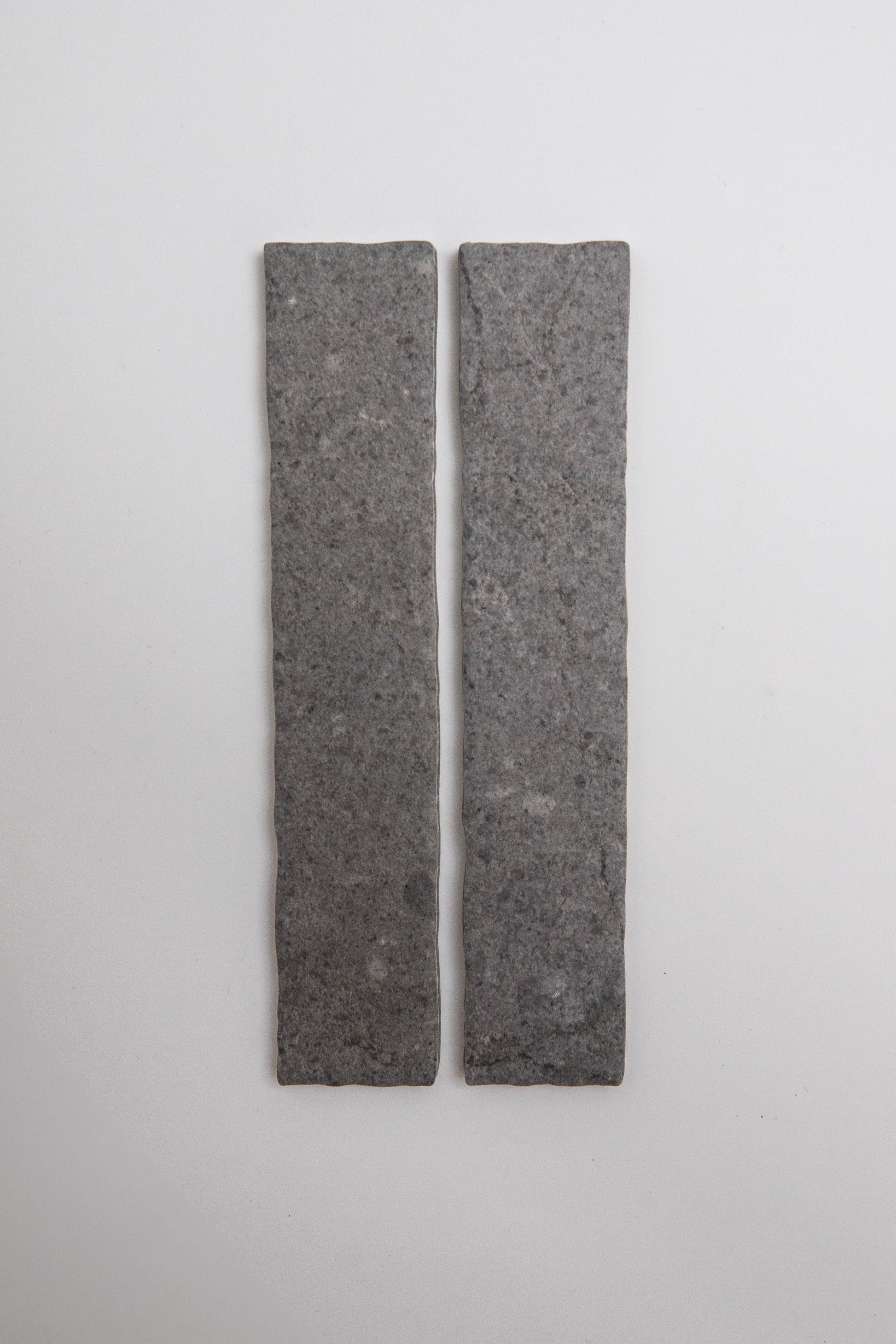 Two rectangular Toba Basilica R11, Sample tiles by Toba stand vertically side by side on a plain, light background.