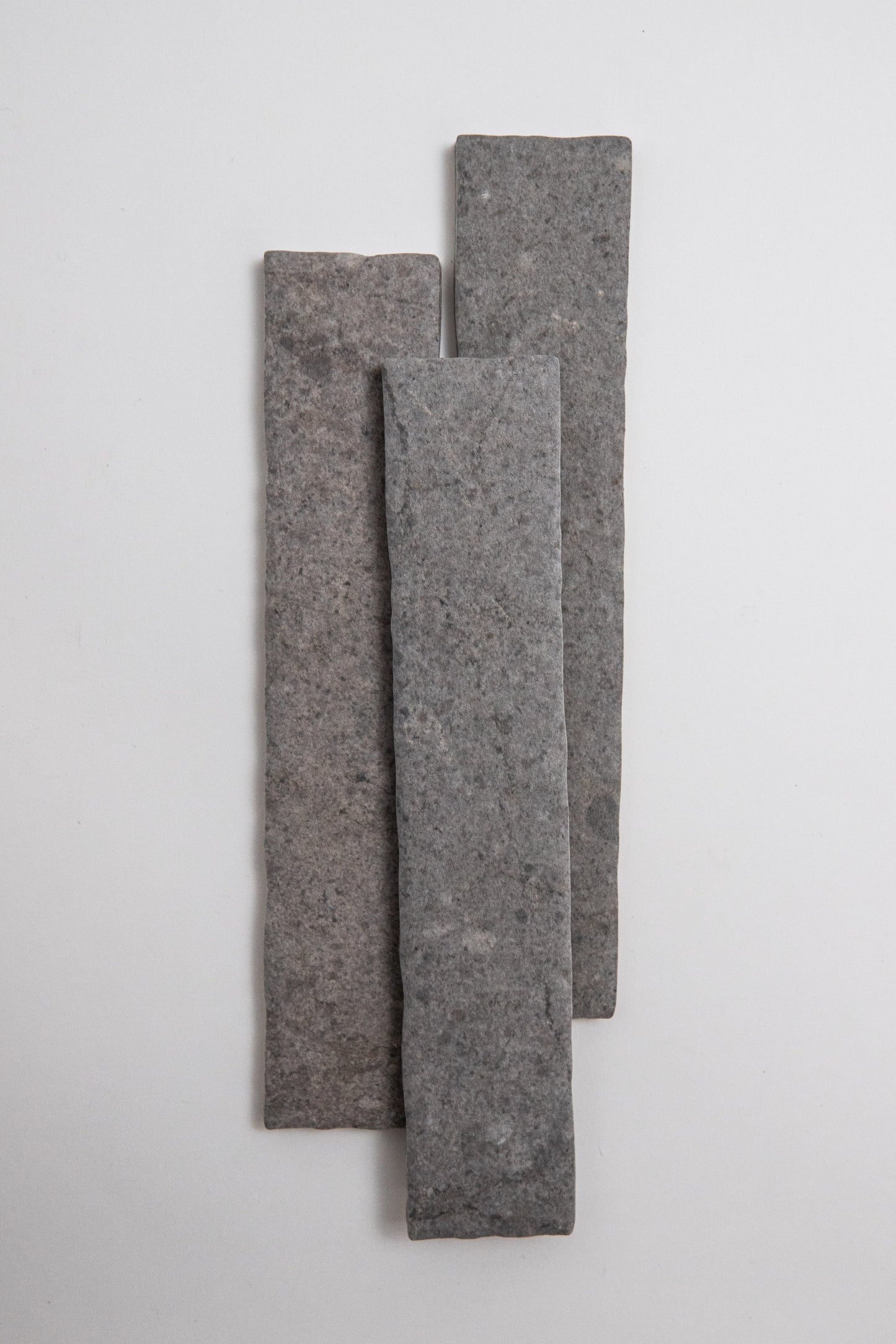 Three Toba Basilica R11 samples of varying heights stand vertically in a staggered row against a white background.
