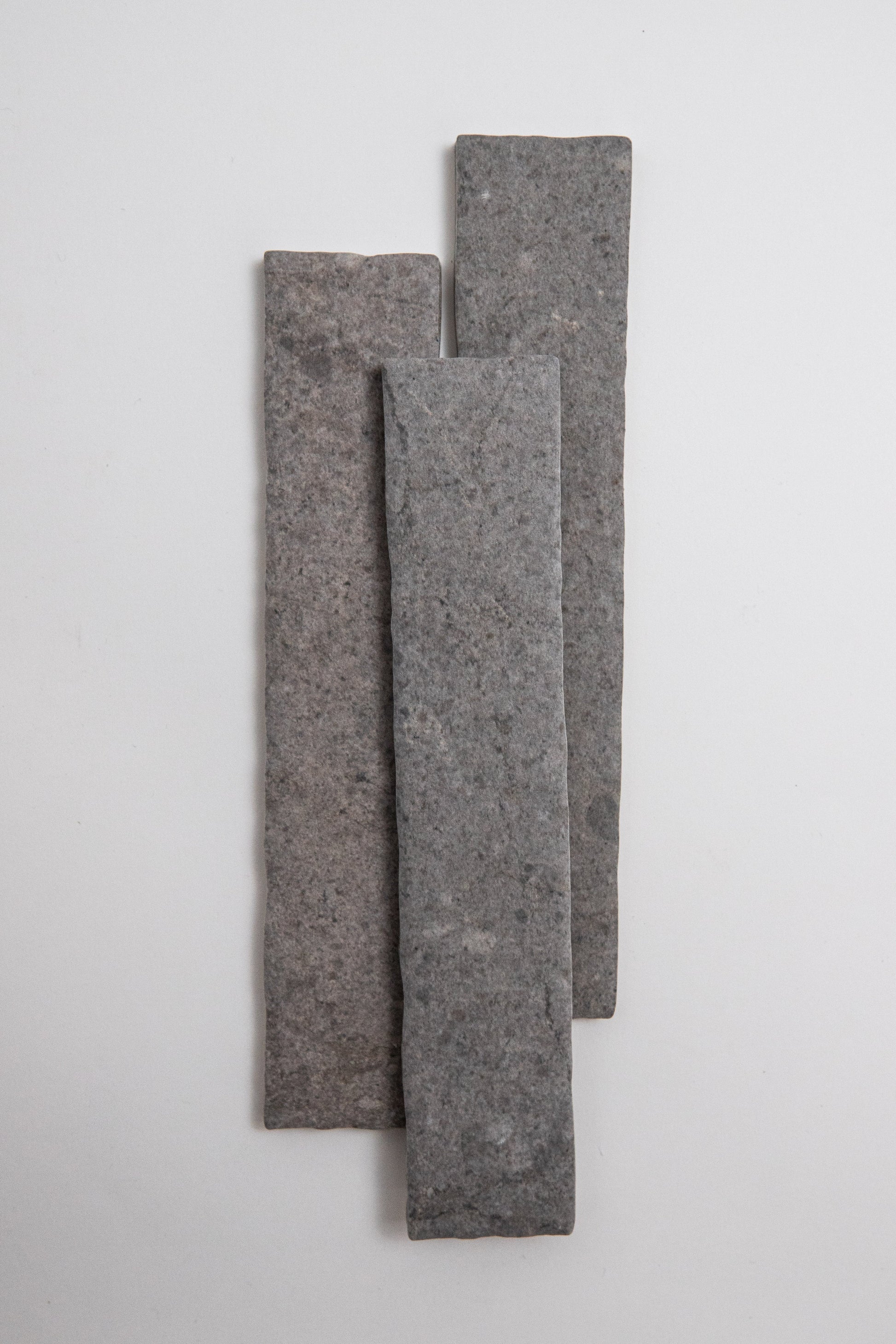 Three Toba Basilica R11 samples of varying heights stand vertically in a staggered row against a white background.