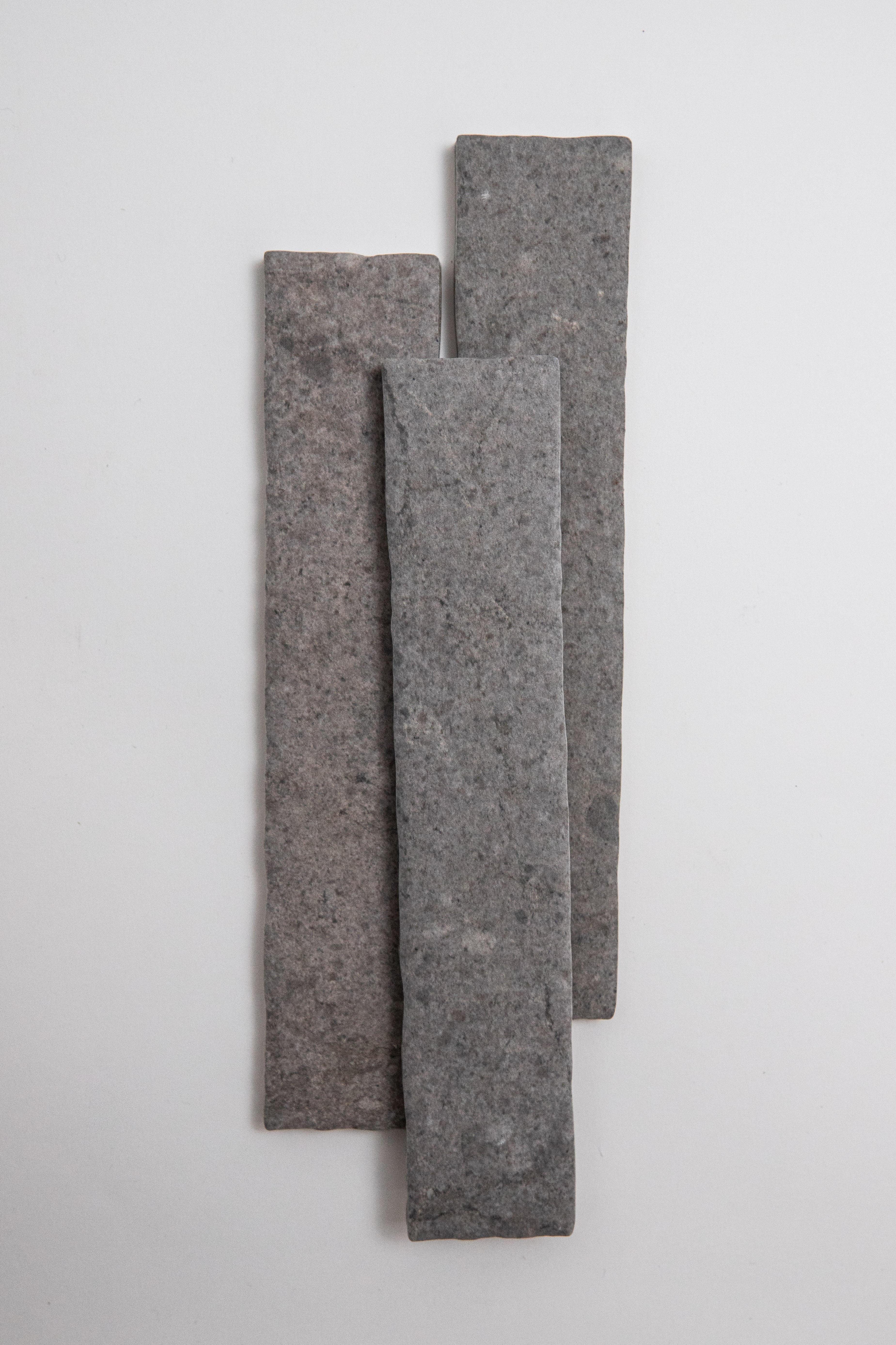 Three Toba Basilica R11 samples of varying heights stand vertically in a staggered row against a white background.
