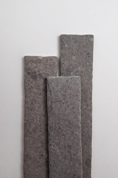 Three Toba Basilica R11 rectangular gray stone tiles stand vertically on a plain white background.