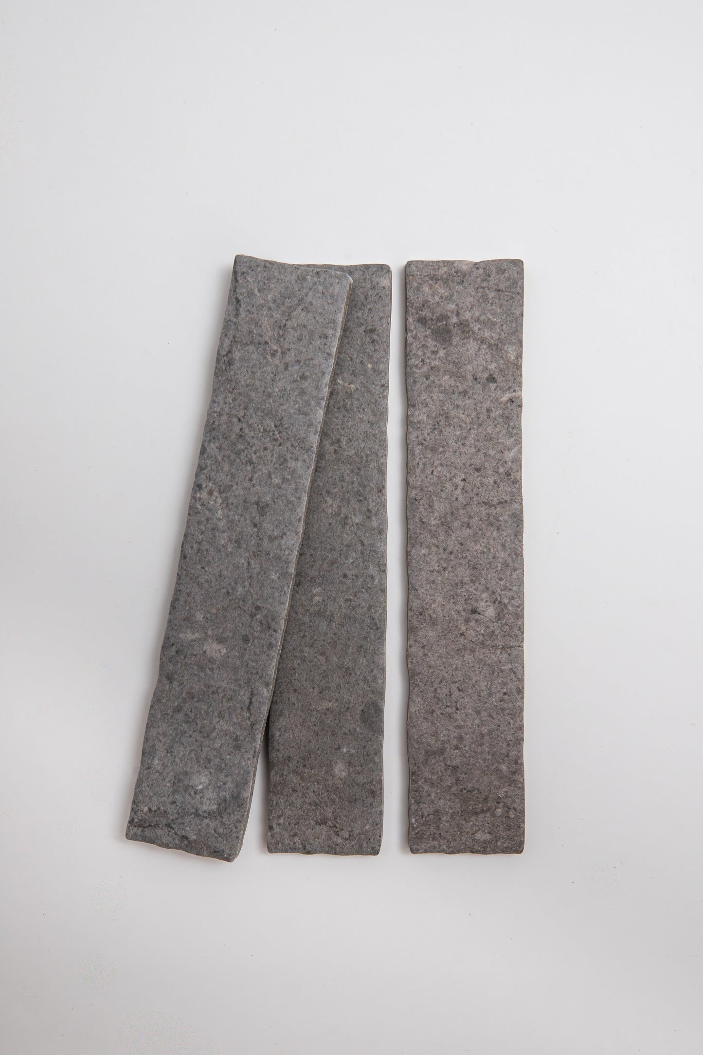 Two Toba Basilica R11, Sample slabs by Toba placed side by side on a plain white background.
