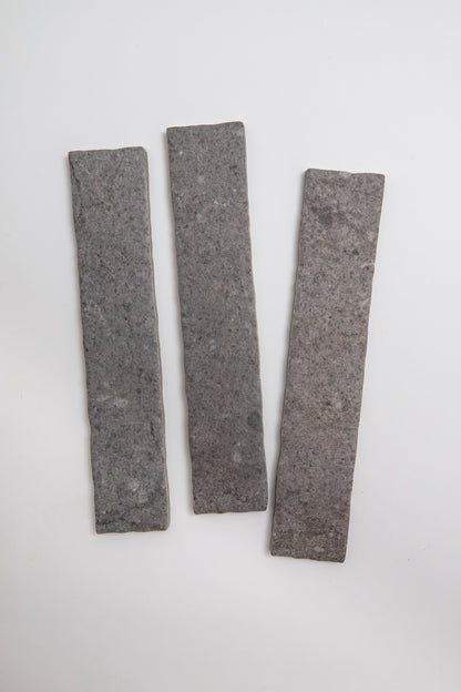 Three Toba Basilica R11 rectangular gray stone tile samples arranged vertically on a white background.