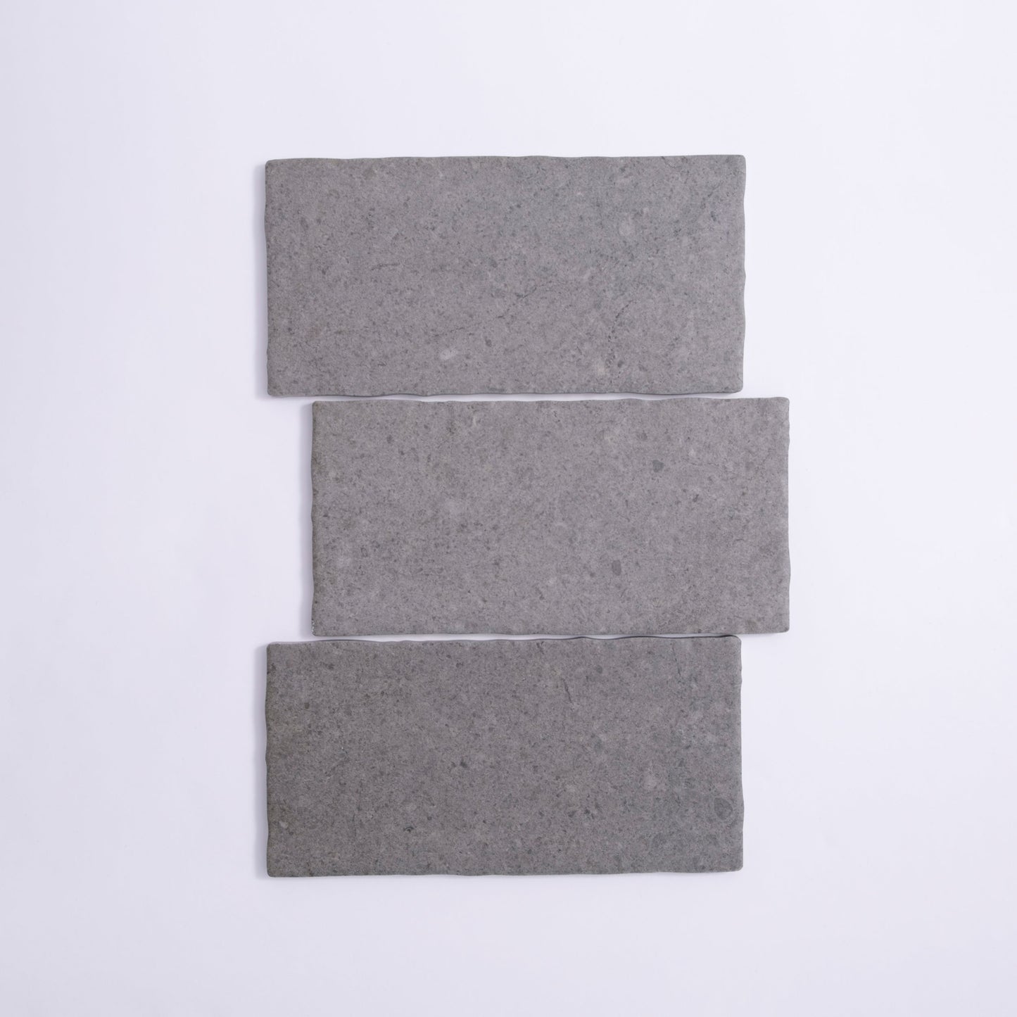 Three Toba Basilica R11 sample tiles from Toba, rectangular and gray, arranged vertically on a white background.