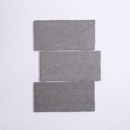 Three Toba Basilica R11 sample tiles from Toba, rectangular and gray, arranged vertically on a white background.