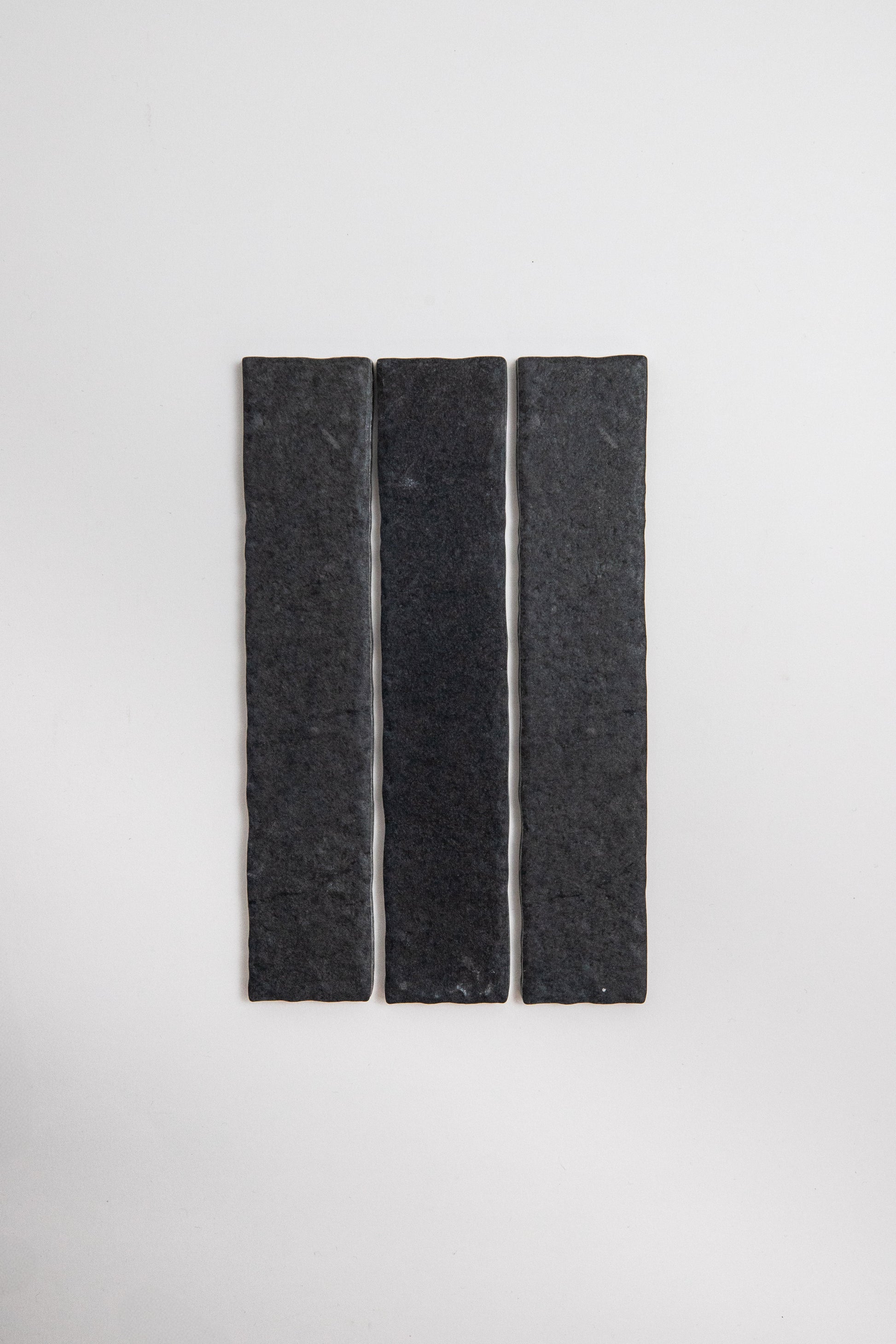 Three narrow Toba Black R11 tiles by Toba are vertically aligned side by side on a plain white background.