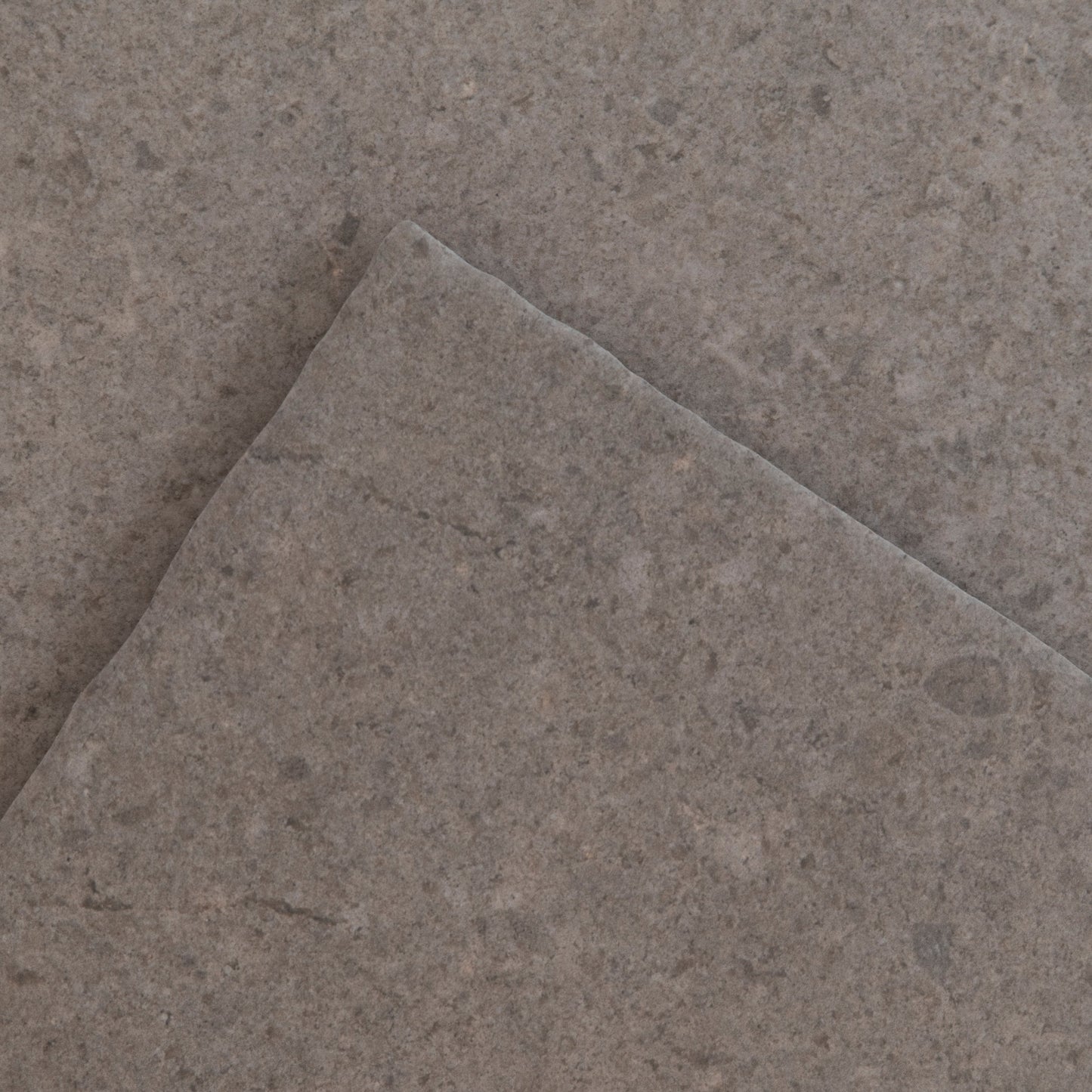 The Toba Brun R11 by New York Cement Tile: a single square gray stone tile on a plain white background.