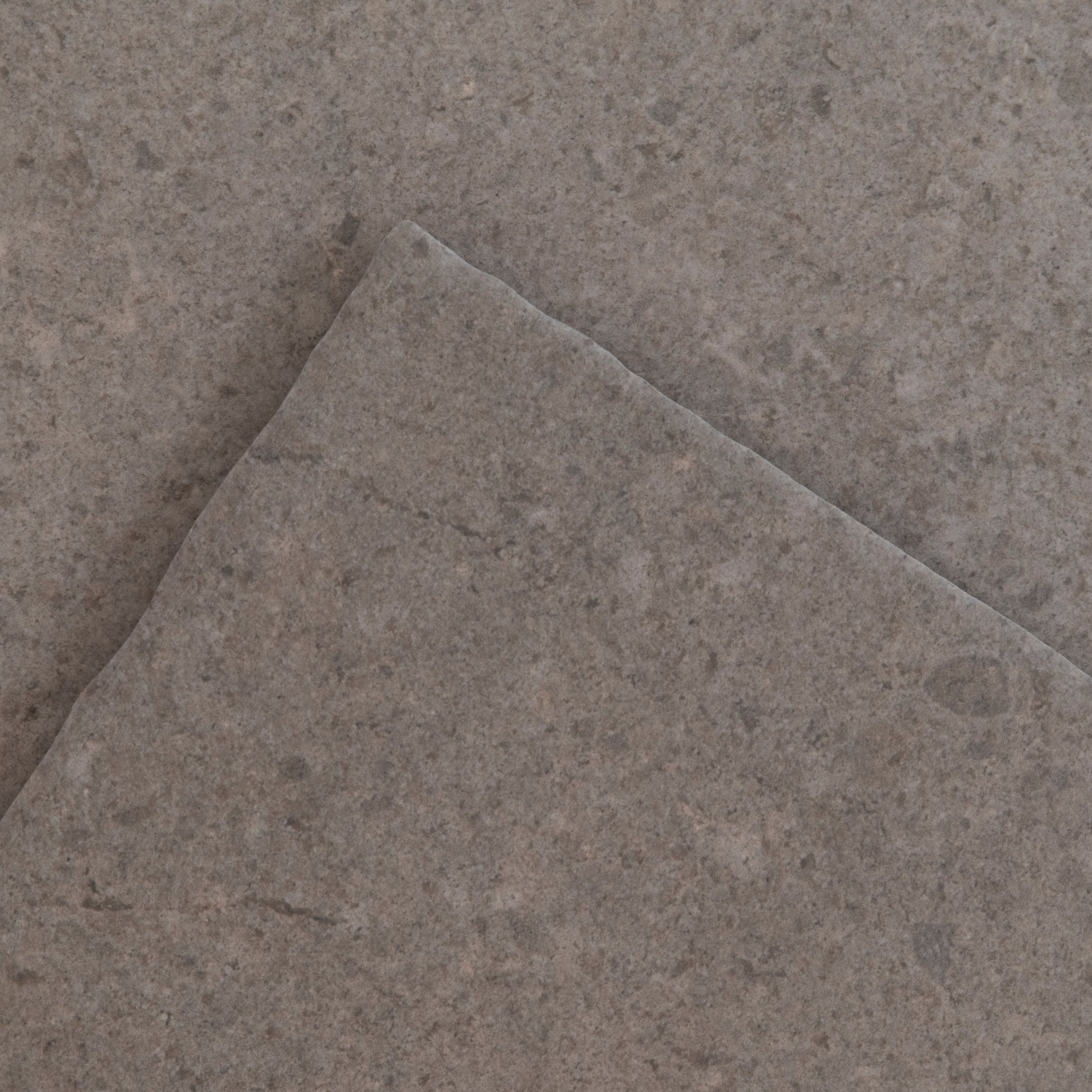 The Toba Brun R11 by New York Cement Tile: a single square gray stone tile on a plain white background.