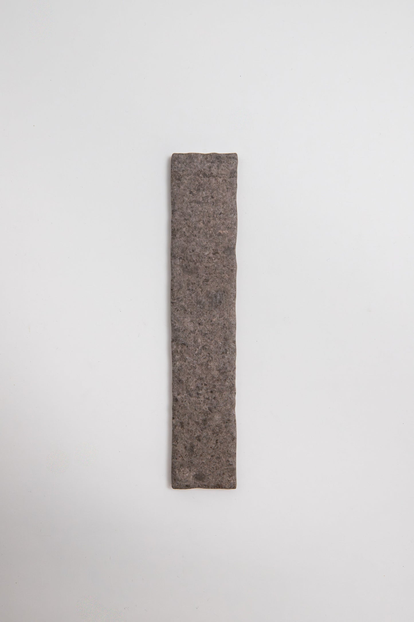 A single Toba Brun R11 tile sample is centered on a plain white background.