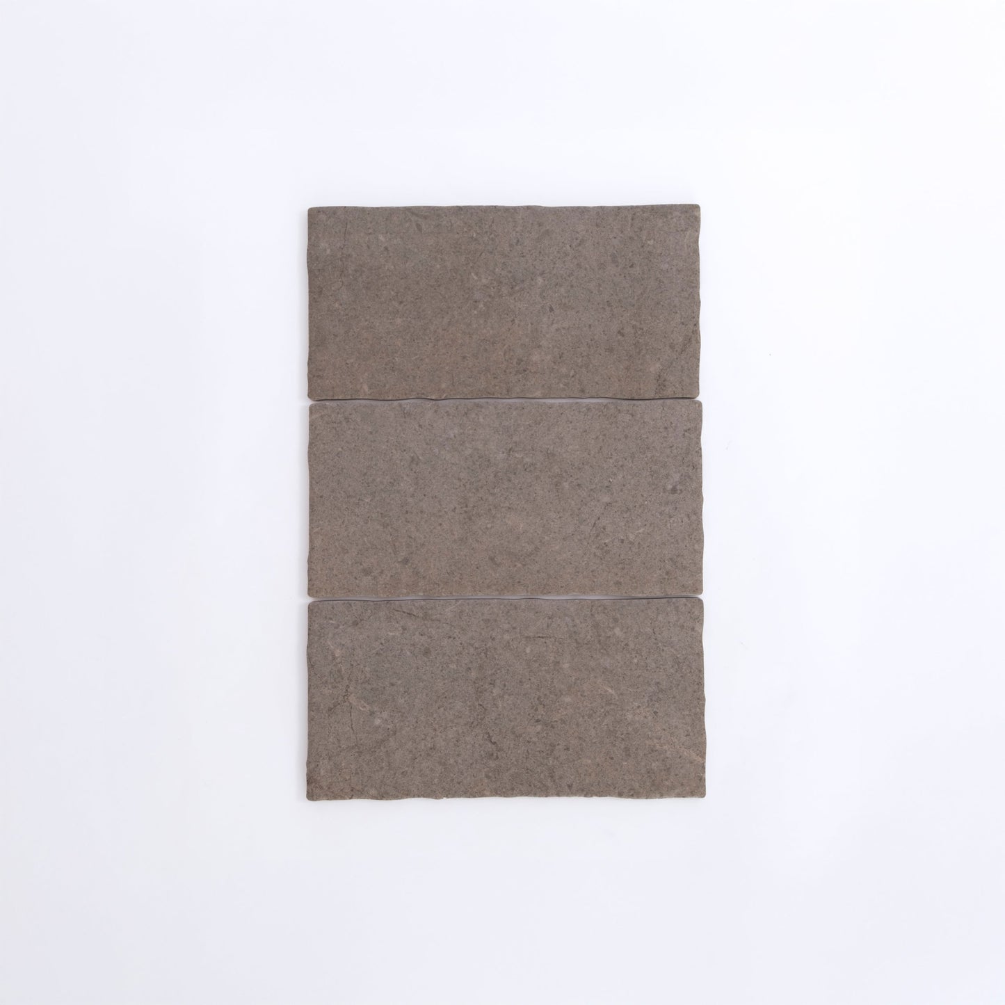 Three Toba Brun R11 rectangular brown stone tiles by Toba are arranged vertically on a plain white background.
