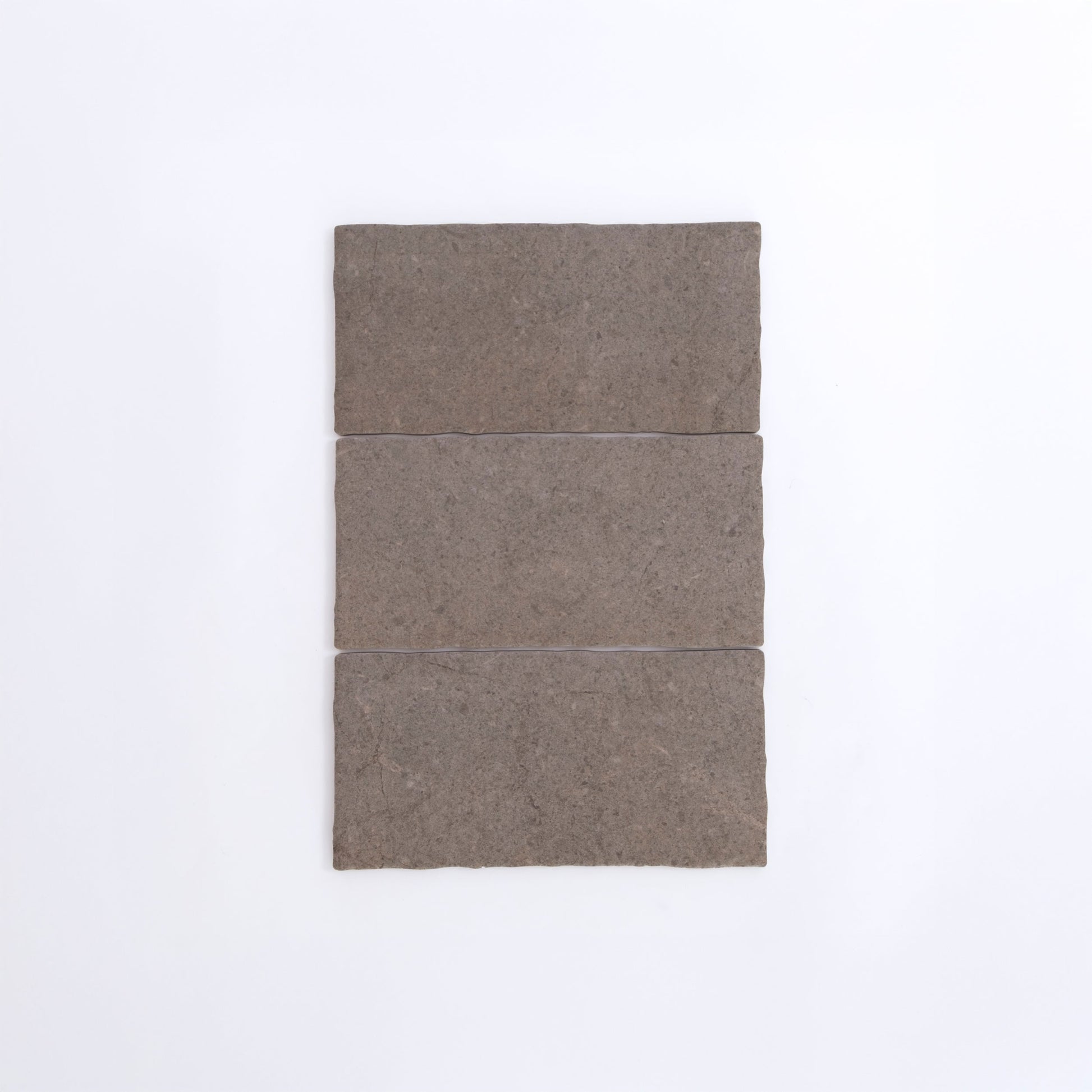 Three Toba Brun R11 rectangular brown stone tiles by Toba are arranged vertically on a plain white background.