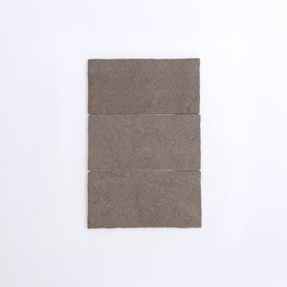 Three Toba Brun R11 rectangular brown stone tiles by Toba are arranged vertically on a plain white background.