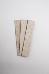 Three Toba Ivory R11 rectangular beige tiles by Toba are arranged side by side on a plain white background.