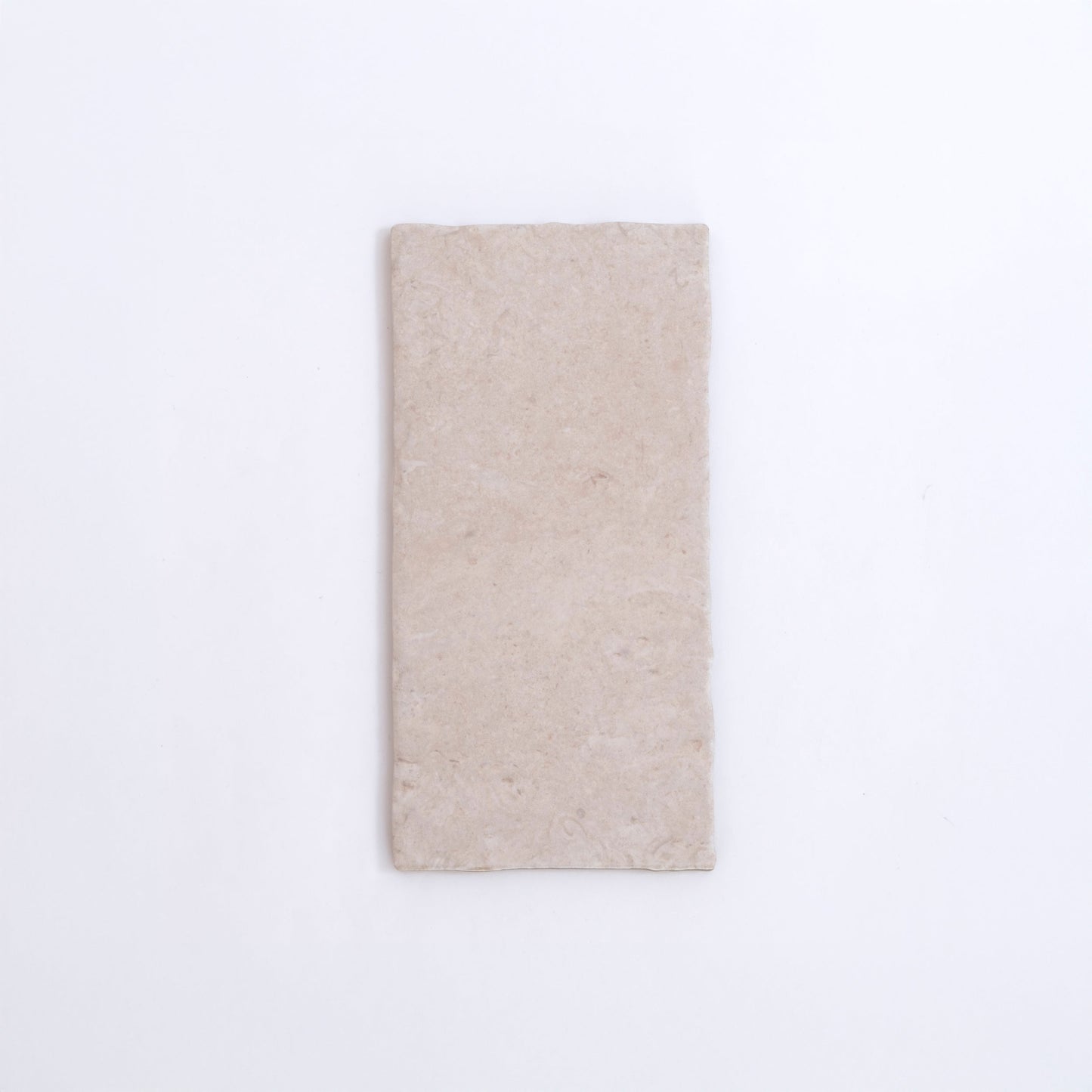 The Toba Ivory R11 by Toba is a rectangular, light beige stone tile shown on a plain white background.