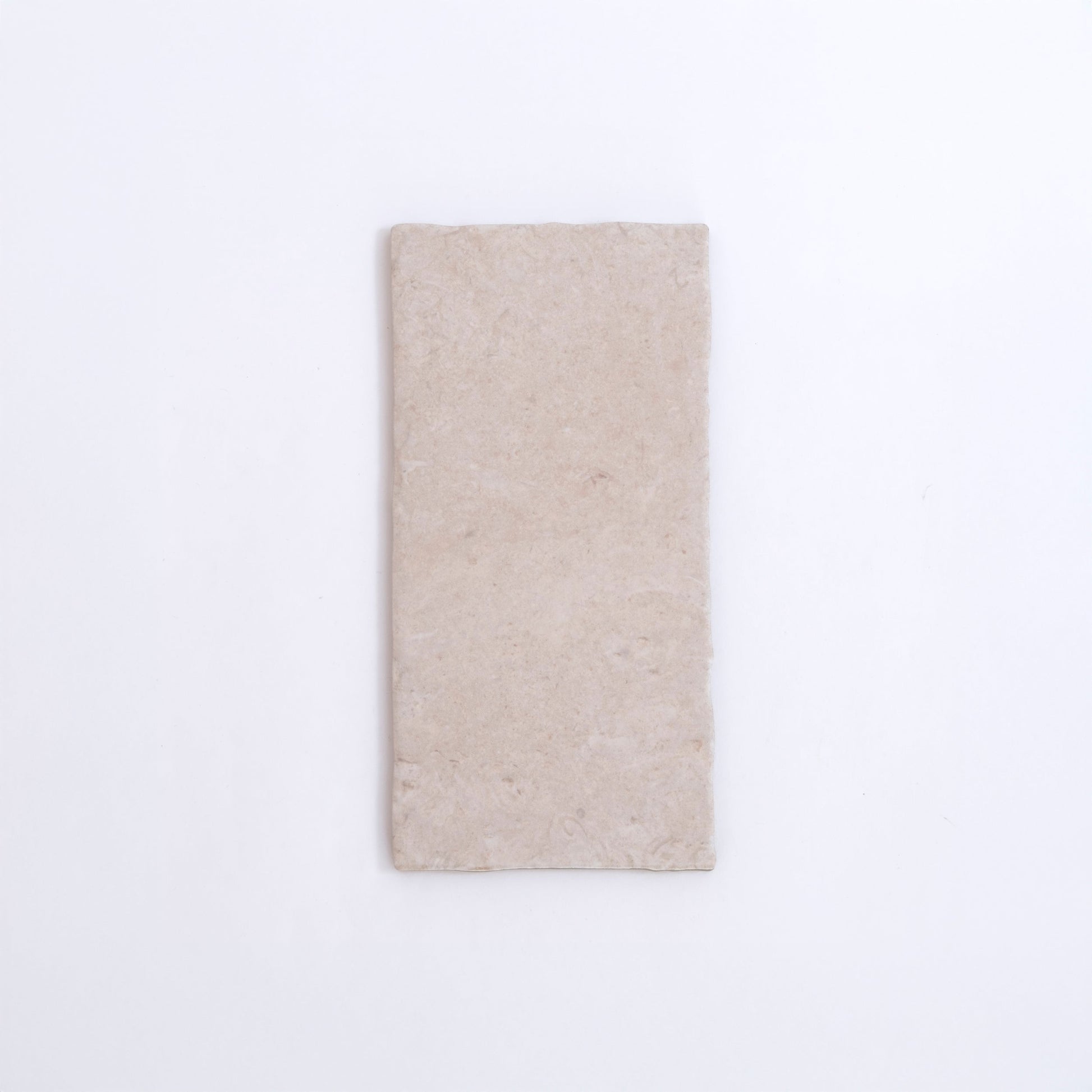 The Toba Ivory R11 by Toba is a rectangular, light beige stone tile shown on a plain white background.