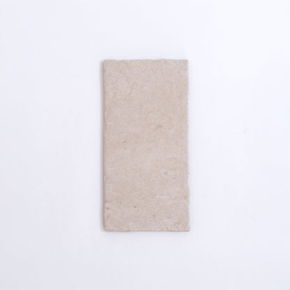 The Toba Ivory R11 by Toba is a rectangular, light beige stone tile shown on a plain white background.